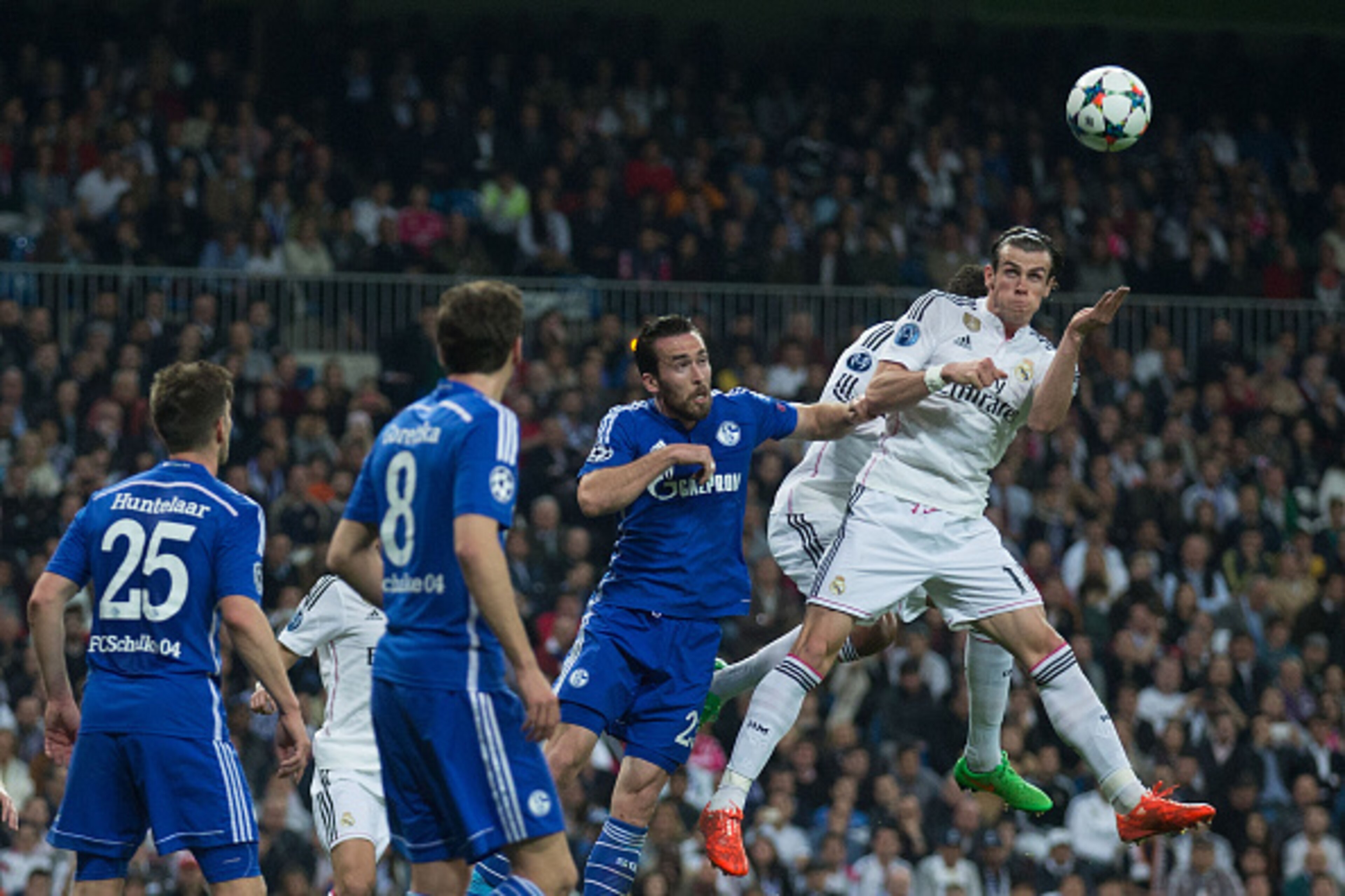 MADRID, SPAIN - MARCH 10: Gareth Bale of Real Madrid CF wins the header after Christian Fuchs of FC Schalke 04 during the UEFA Champions League round of 16 second leg match between Real Madrid CF and FC Schalke 04 at Estadio Santiago Bernabeu on March 10,