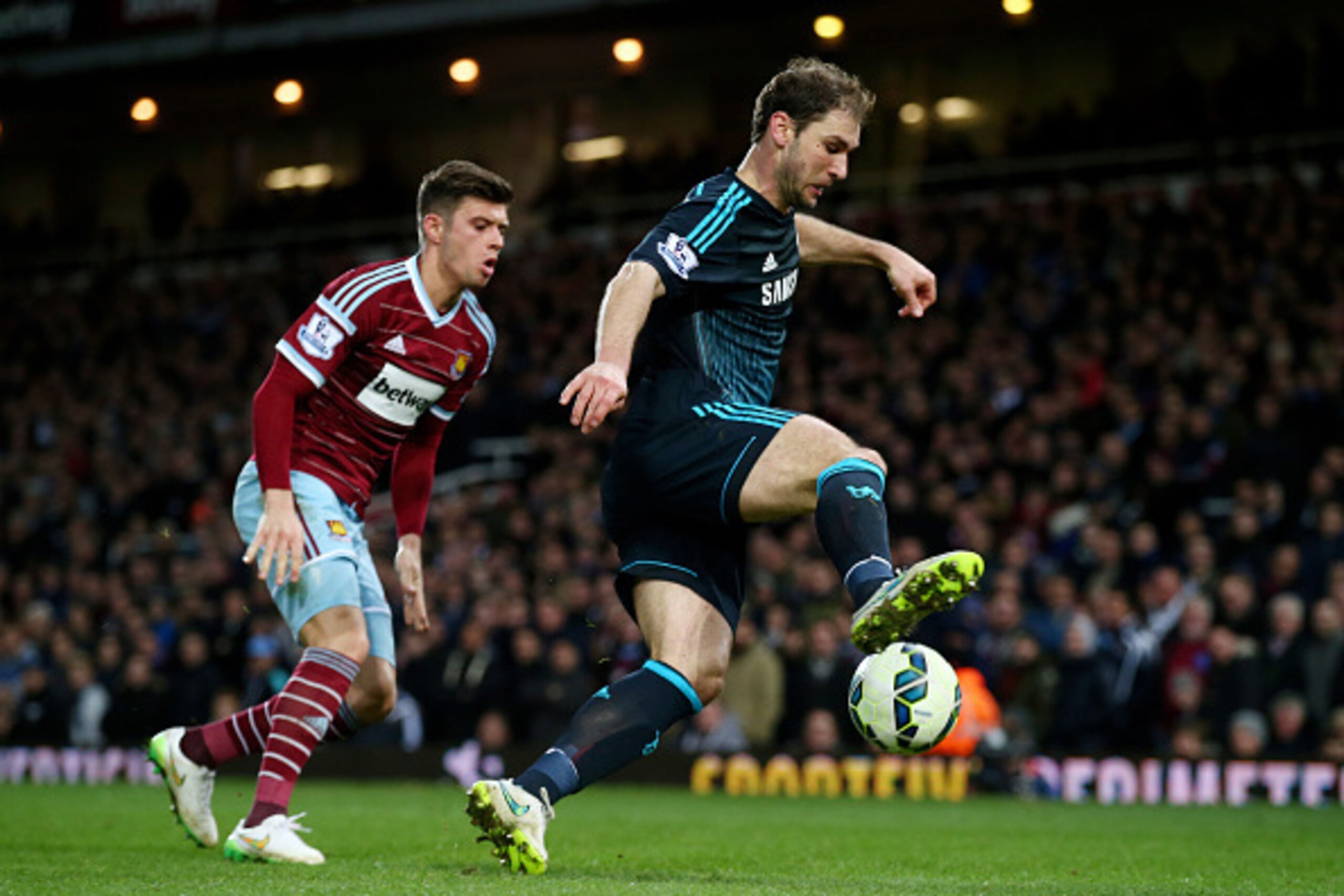 LONDON, ENGLAND - MARCH 04:  Branislav Ivanovic of Chelsea is challenged by Aaron Cresswell of West Ham during the Barclays Premier League match between West Ham and Chelsea at the Boleyn Ground on March 4, 2015 in London, England.  (Photo by Clive Rose/G