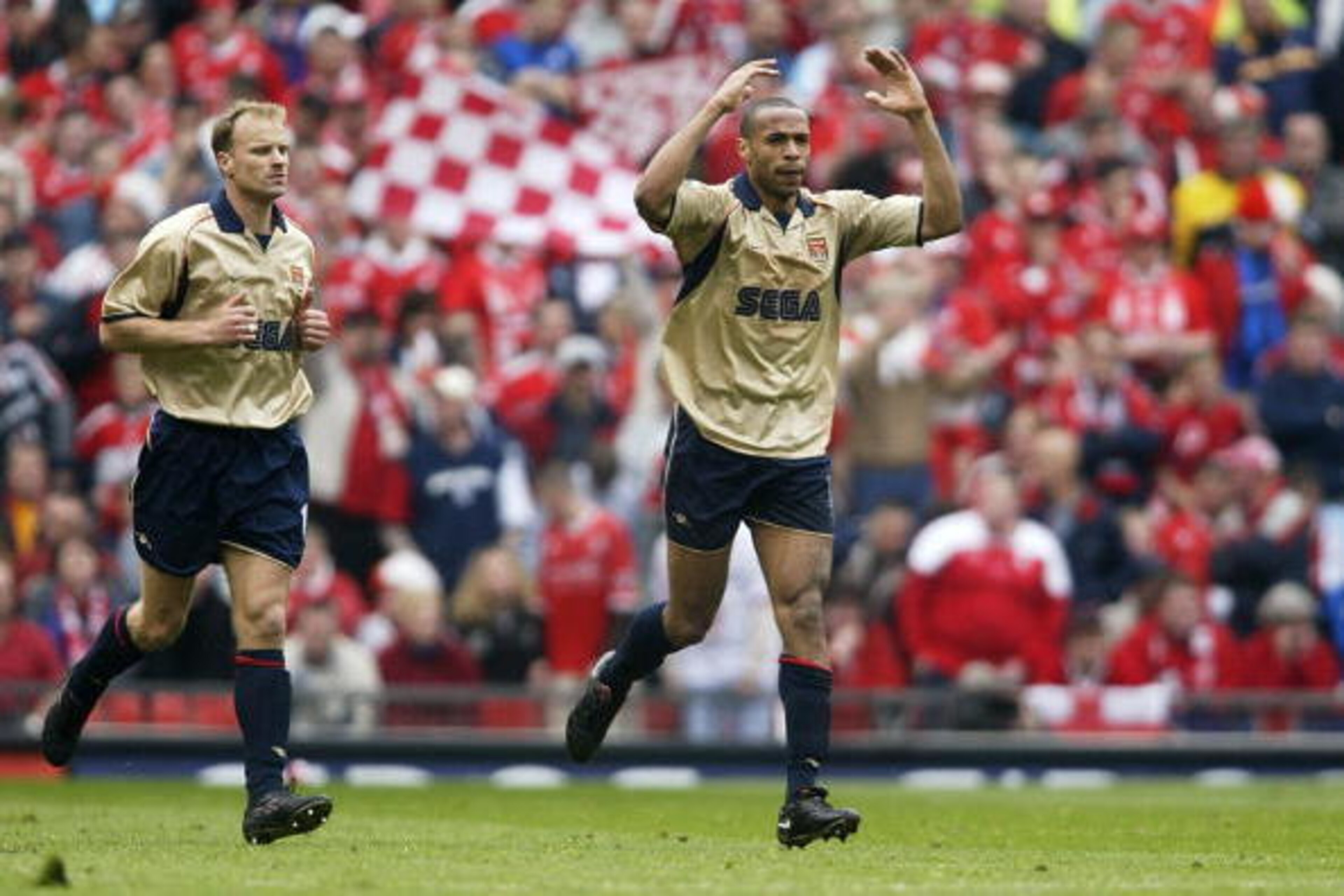 14 Apr 2002: Thierry Henry of Arsenal celebrates Middlesbrough's own goal alongside team mate Dennis Bergkamp during the AXA sponsored FA Cup Semi-final match between Middlesbrough and Arsenal at Old Trafford in Manchester, England. Arsenal won 1-0. DIGI 14 Apr 2002: Thierry Henry of Arsenal celebrates Middlesbrough's own goal alongside team mate Dennis Bergkamp during the AXA sponsored FA Cup Semi-final match between Middlesbrough and Arsenal at Old Trafford in Manchester, England. Arsenal won 1-0. DIGI