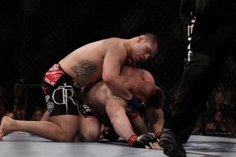 Cain Velasquez pounds Brock Lesnar.