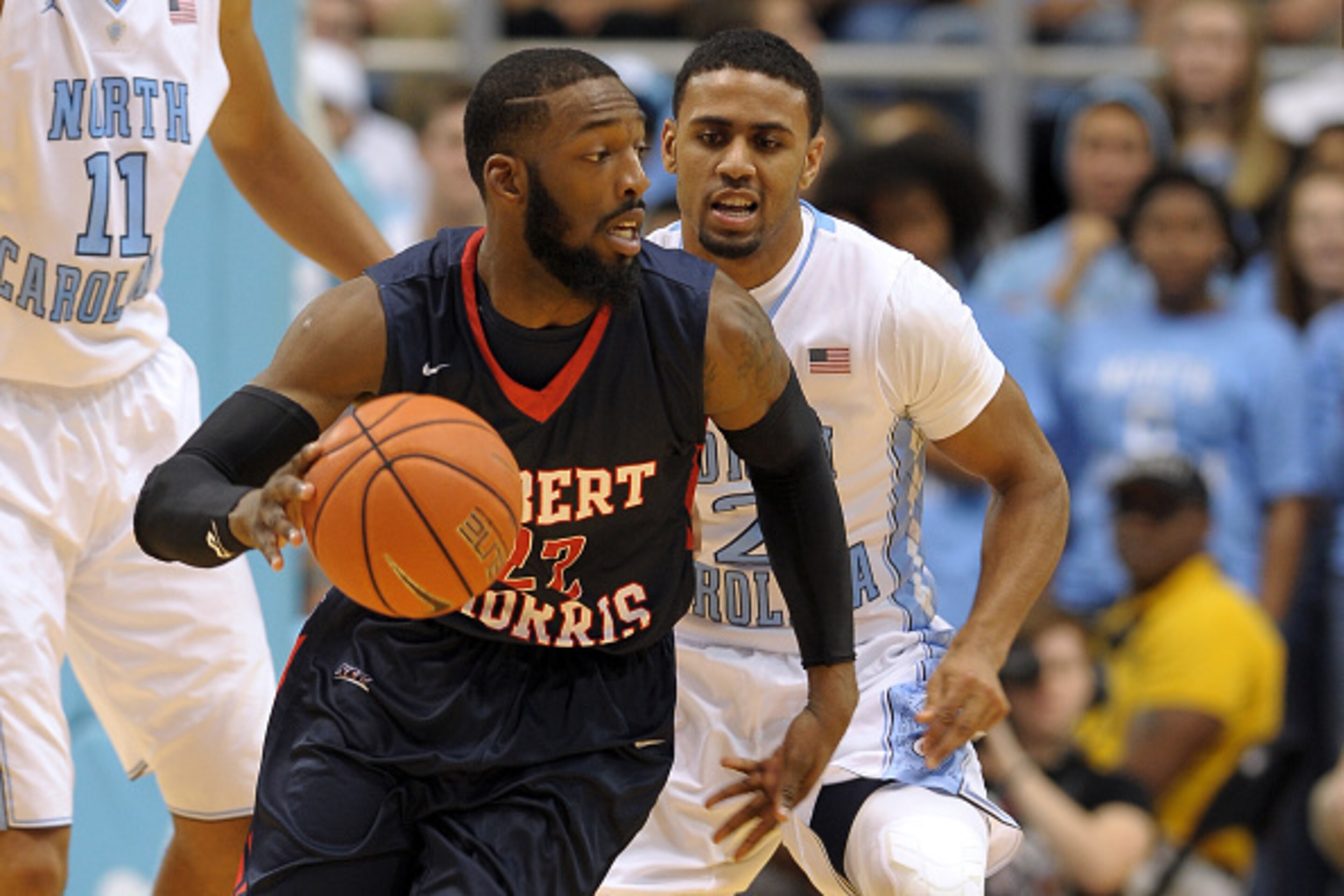 CHAPEL HILL, NC - NOVEMBER 16: Lucky Jones #22 of the Robert Morris Colonials moves the ball against Joel Berry II #2 of the North Carolina Tar Heels during their game at the Dean Smith Center on November 16, 2014 in Chapel Hill, North Carolina. (Photo by