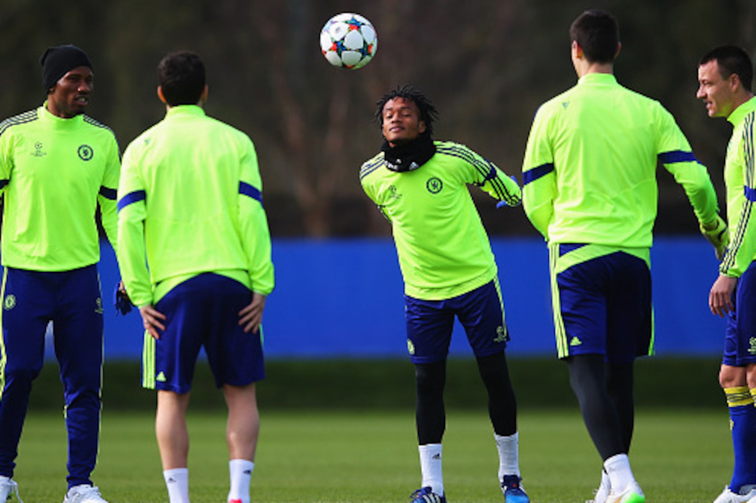 COBHAM, ENGLAND - MARCH 10:  Juan Cuadrado (C) heads the ball alongside team mates during a Chelsea training session ahead of the UEFA Champions League Round of 16 second leg match against Paris Saint-Germain at Chelsea Training Ground on March 10, 2015 i