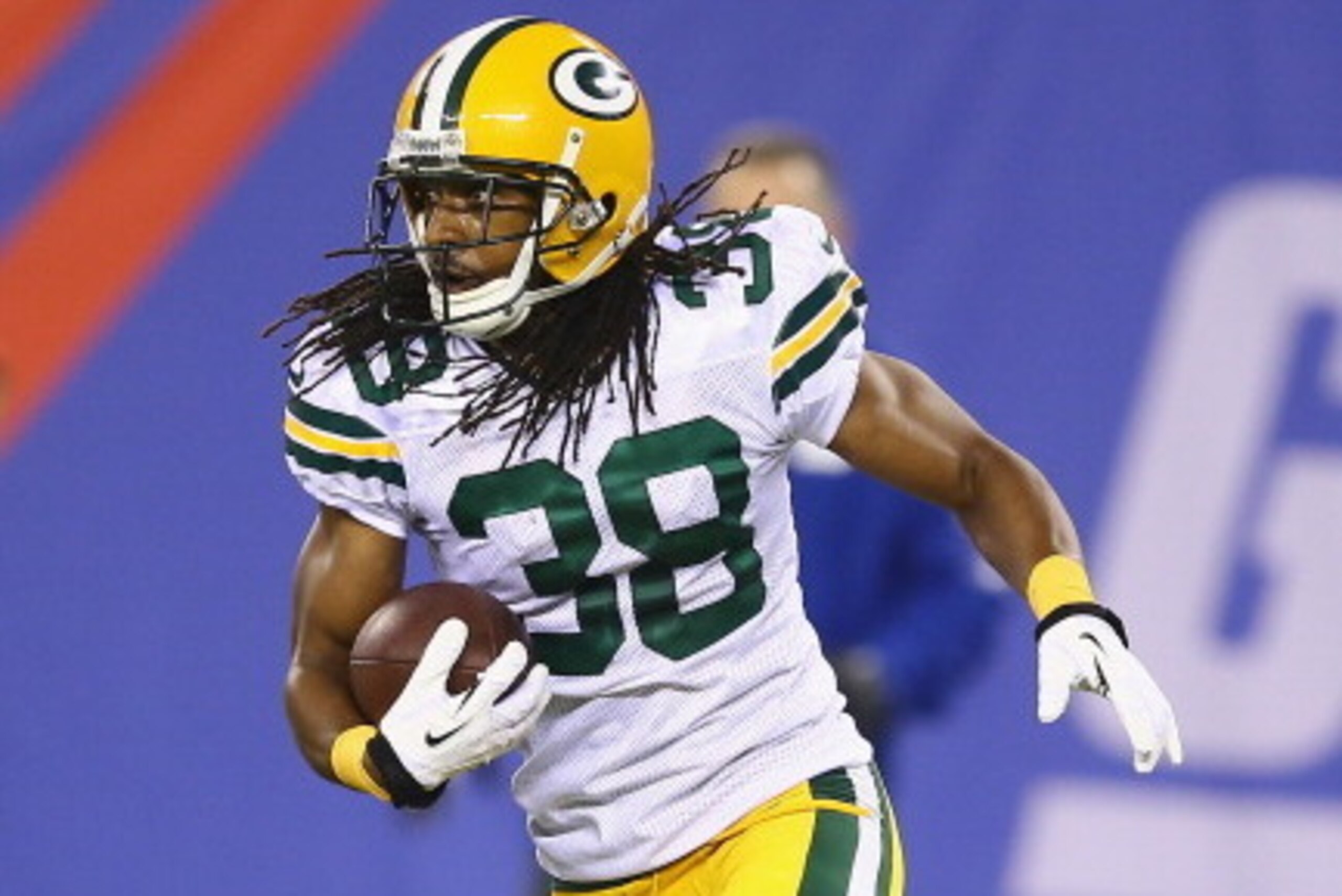 EAST RUTHERFORD, NJ - NOVEMBER 17:  Tramon Williams #38 of the Green Bay Packers runs after making an interception against the New York Giants  during their game at MetLife Stadium on November 17, 2013 in East Rutherford, New Jersey.  (Photo by Al Bello/G