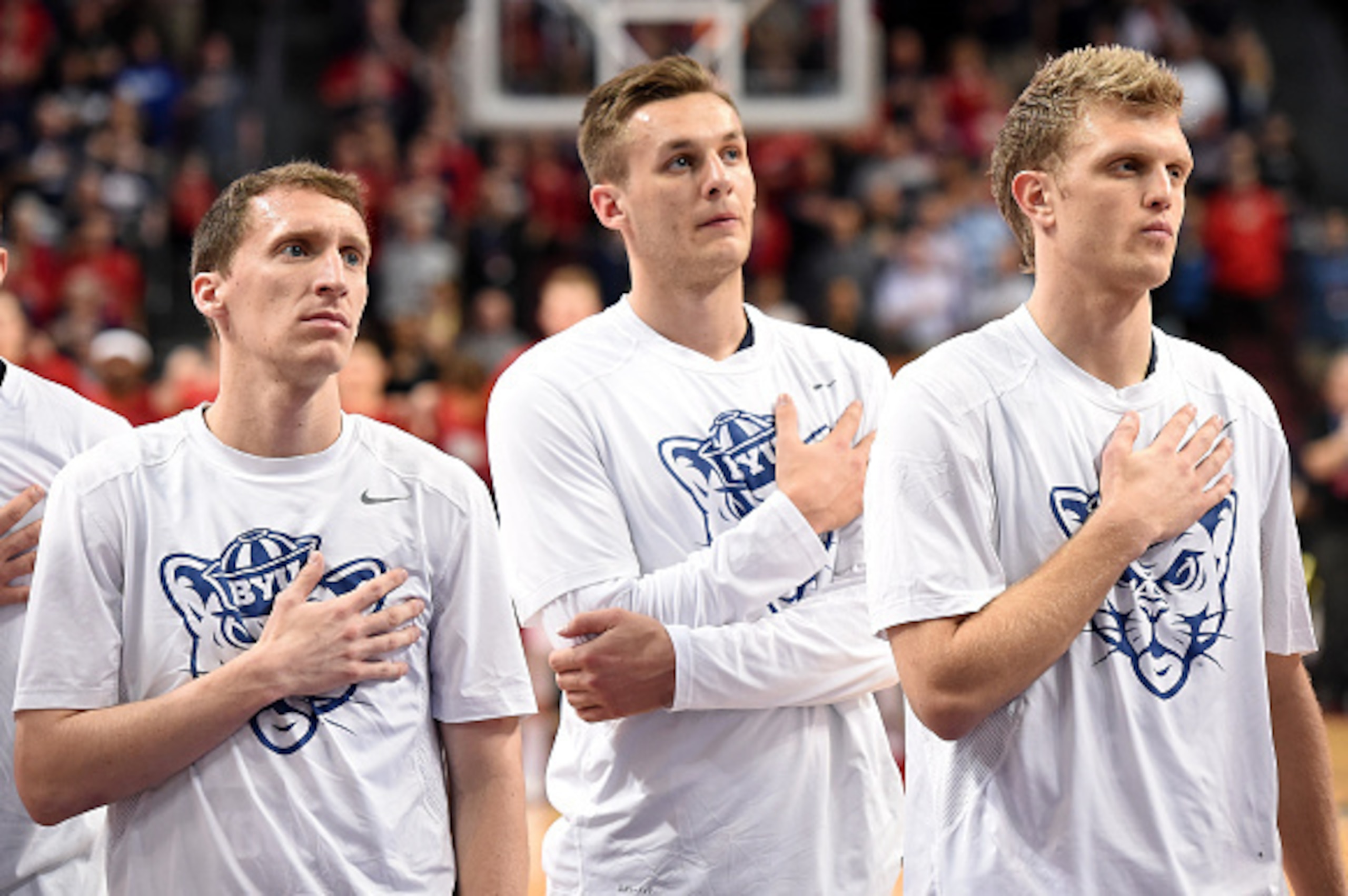 LAS VEGAS, NV - MARCH 10:  (L-R) Skyler Halford #23, Kyle Collinsworth #5 and Tyler Haws #3 of the Brigham Young Cougars stand on the court during the performance of the American national anthem before the championship game of the West Coast Conference Ba