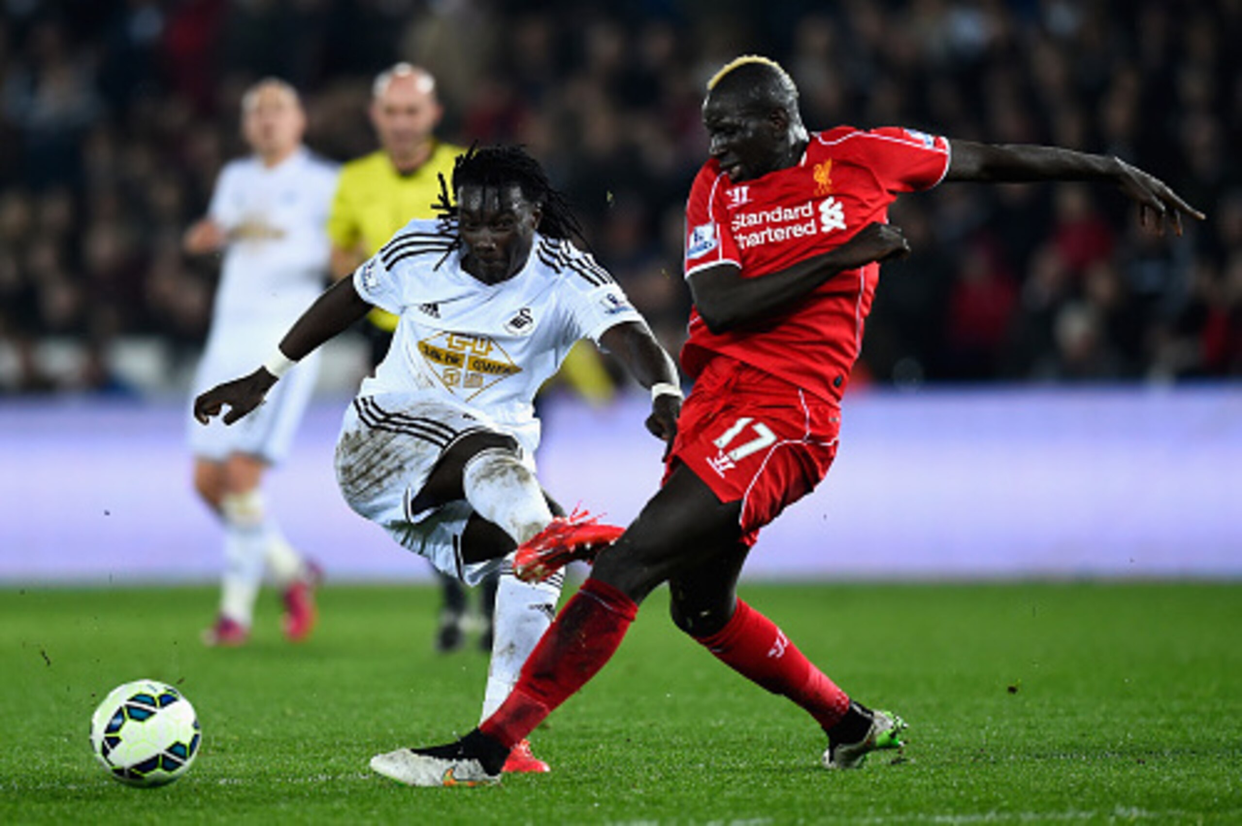 SWANSEA, WALES - MARCH 16: Swansea striker Bafetimbi Gomis is challenged by Mamadou Sakho during the Barclays Premiership match between Swansea City and Liverpool at Liberty Stadium on March 16, 2015 in Swansea, Wales. (Photo by Stu Forster/Getty Images SWANSEA, WALES - MARCH 16: Swansea striker Bafetimbi Gomis is challenged by Mamadou Sakho during the Barclays Premiership match between Swansea City and Liverpool at Liberty Stadium on March 16, 2015 in Swansea, Wales. (Photo by Stu Forster/Getty Images