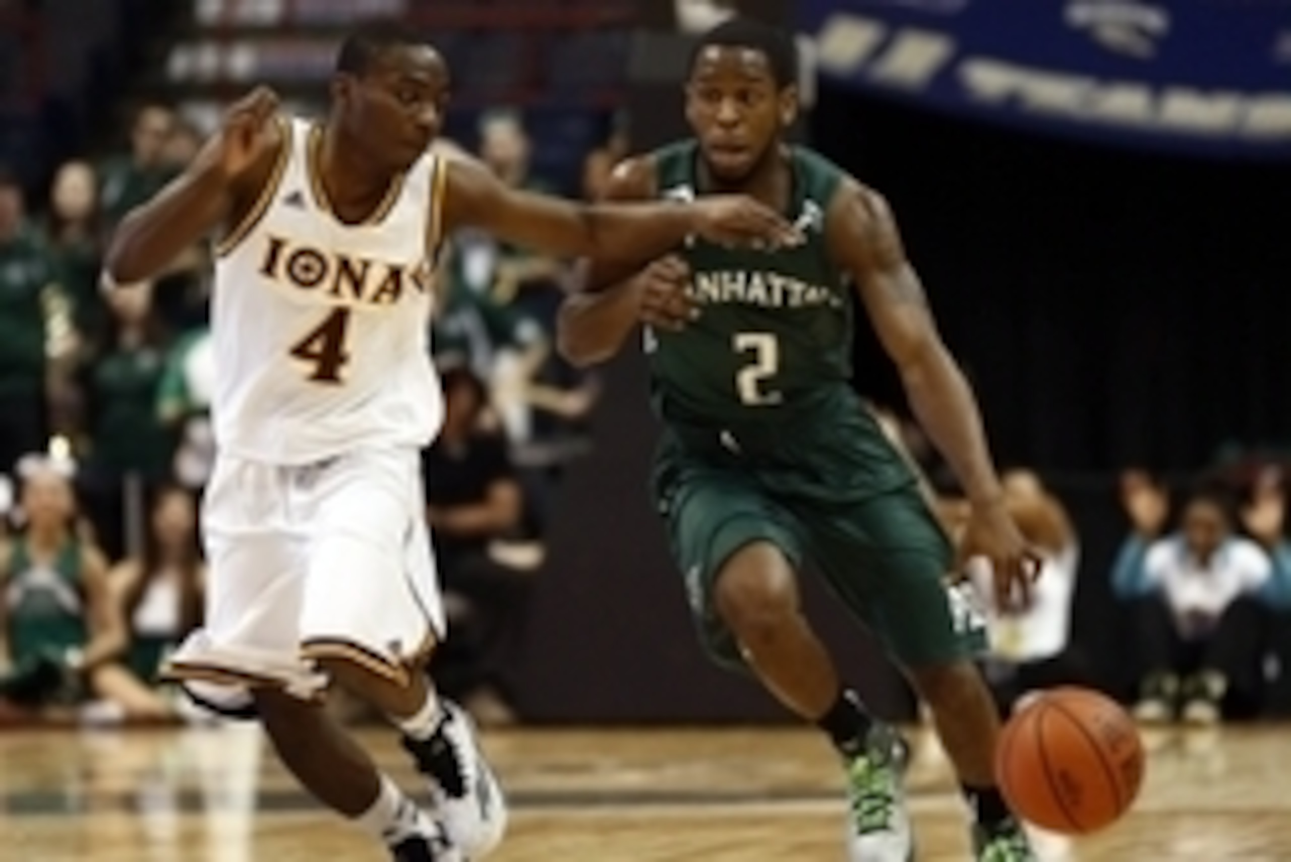 Mar 9, 2015; Albany, NY, USA; Manhattan Jaspers guard Tyler Wilson (2) dribbles the ball as Iona Gaels guard Schadrac Casimir (4) defends during the first half in the championship game of the MAAC Conference Tournament at Times Union Center. Mandatory Cre