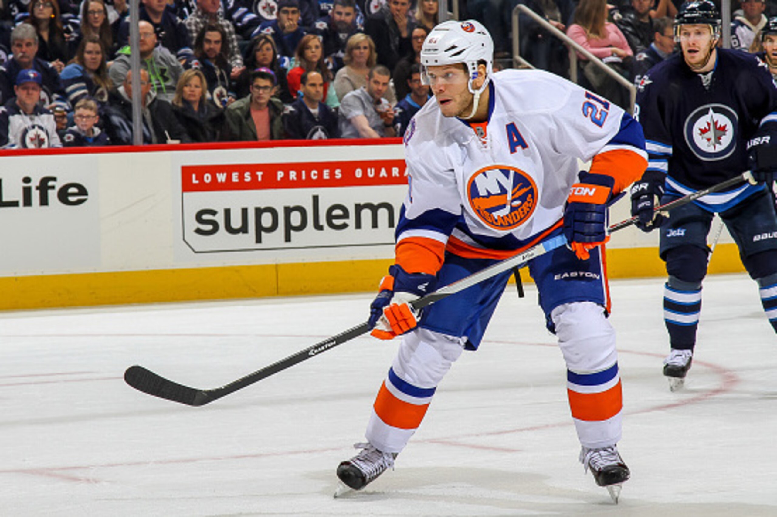 WINNIPEG, CANADA - DECEMBER 31: Kyle Okposo #21 of the New York Islanders keeps an eye on the play during first period action against the Winnipeg Jets on December 31, 2014 at the MTS Centre in Winnipeg, Manitoba, Canada. The Isles defeated the Jets 5-2. 