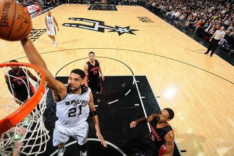 SAN ANTONIO, TX - MARCH 10:  Tim Duncan #21 of the San Antonio Spurs goes to the basket against the Toronto Raptors on March 10, 2015 at the AT&T Center in San Antonio, Texas. NOTE TO USER: User expressly acknowledges and agrees that, by downloading and o