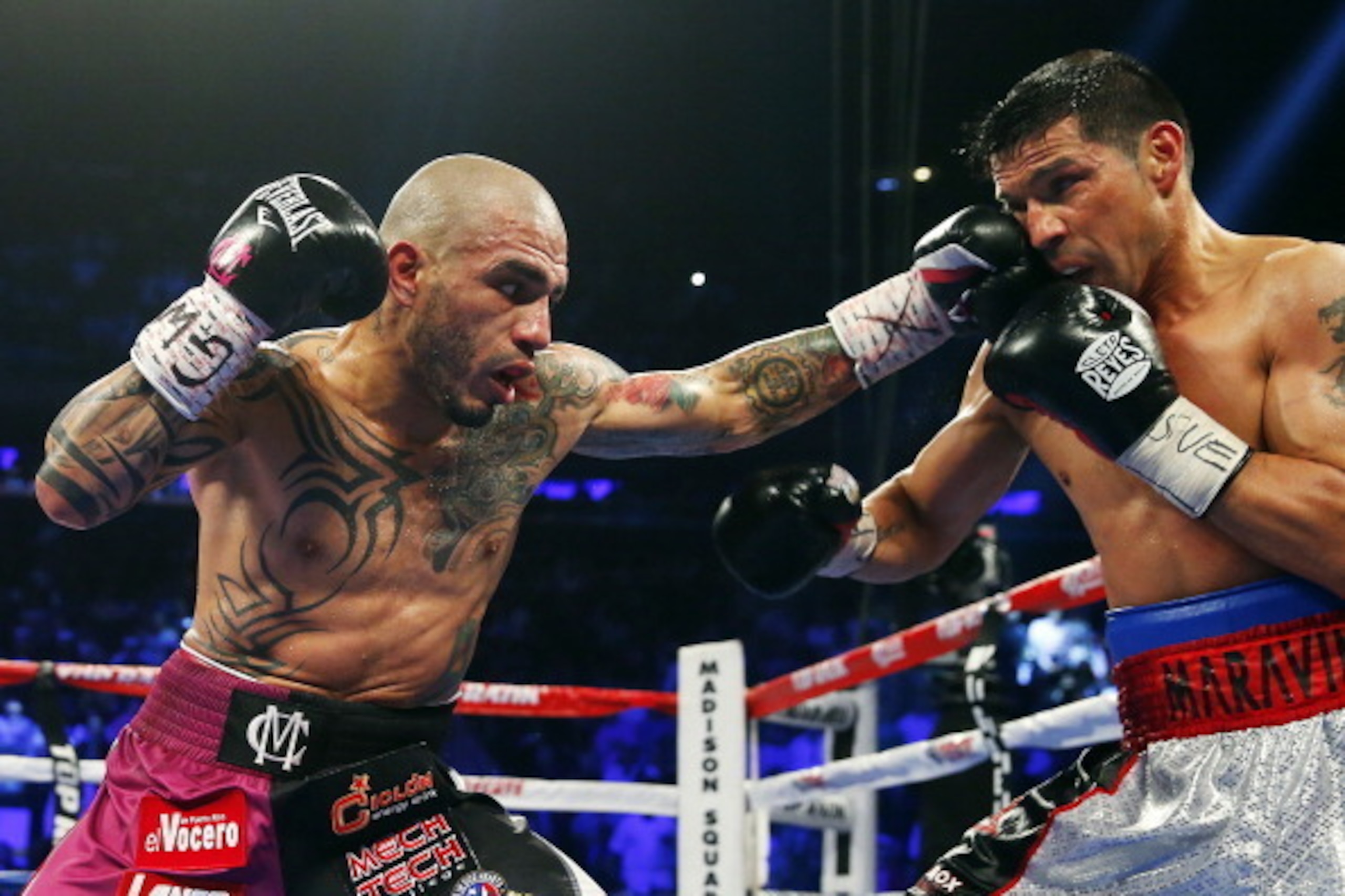 NEW YORK, NY - JUNE 07: Miguel Cotto of Puerto Rico lands a left punch to the face of Sergio Martinez of Argentina during the third round of the WBC Middleweight Championship fight on June 7, 2014 at Madison Square Garden in New York City. Cotto won by a NEW YORK, NY - JUNE 07: Miguel Cotto of Puerto Rico lands a left punch to the face of Sergio Martinez of Argentina during the third round of the WBC Middleweight Championship fight on June 7, 2014 at Madison Square Garden in New York City. Cotto won by a