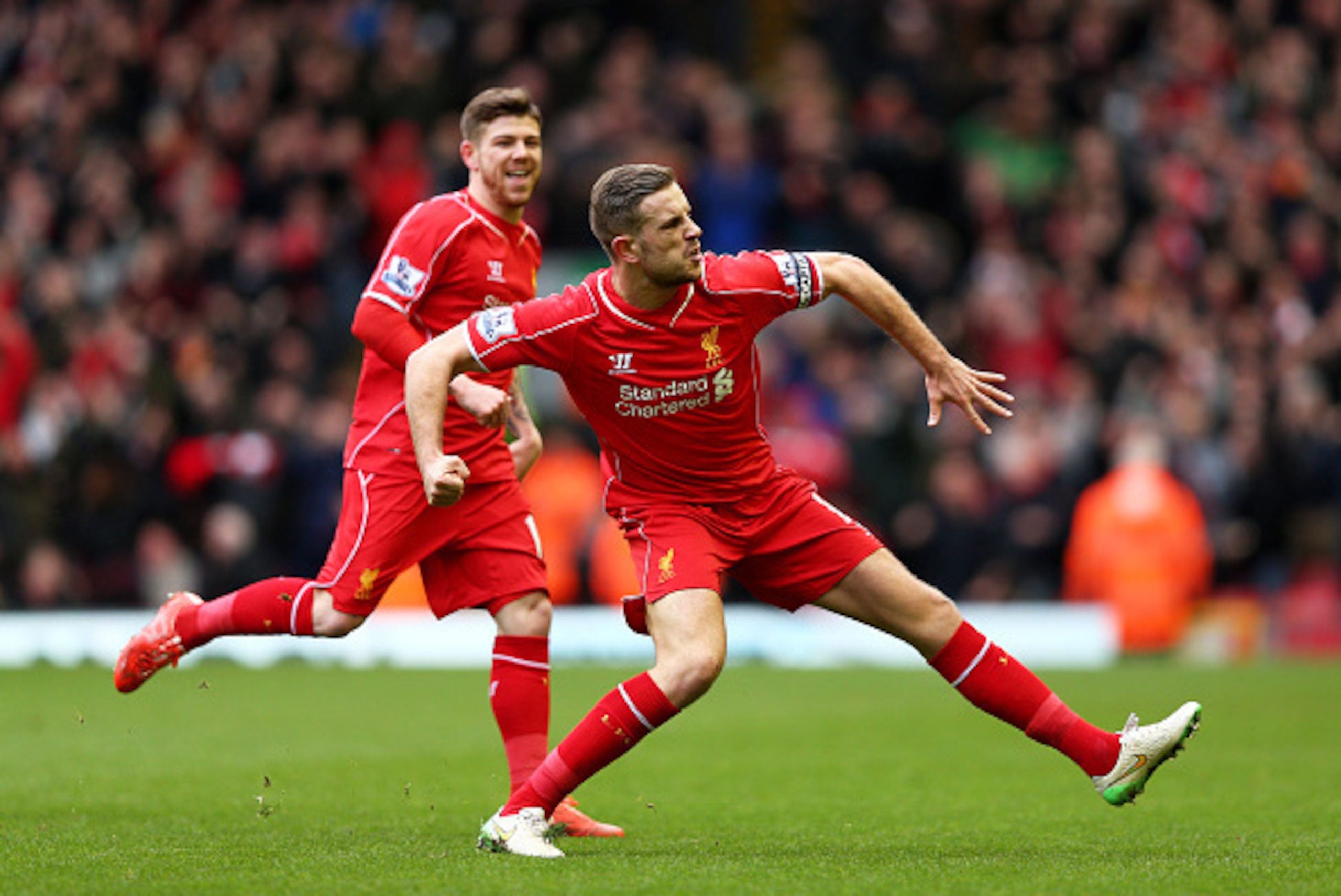 LIVERPOOL, ENGLAND - MARCH 01:  Jordan Henderson (R) of Liverpool celebrates after scoring the opening goal during the Barclays Premier League match between Liverpool and Manchester City at Anfield on March 1, 2015 in Liverpool, England.  (Photo by Clive 