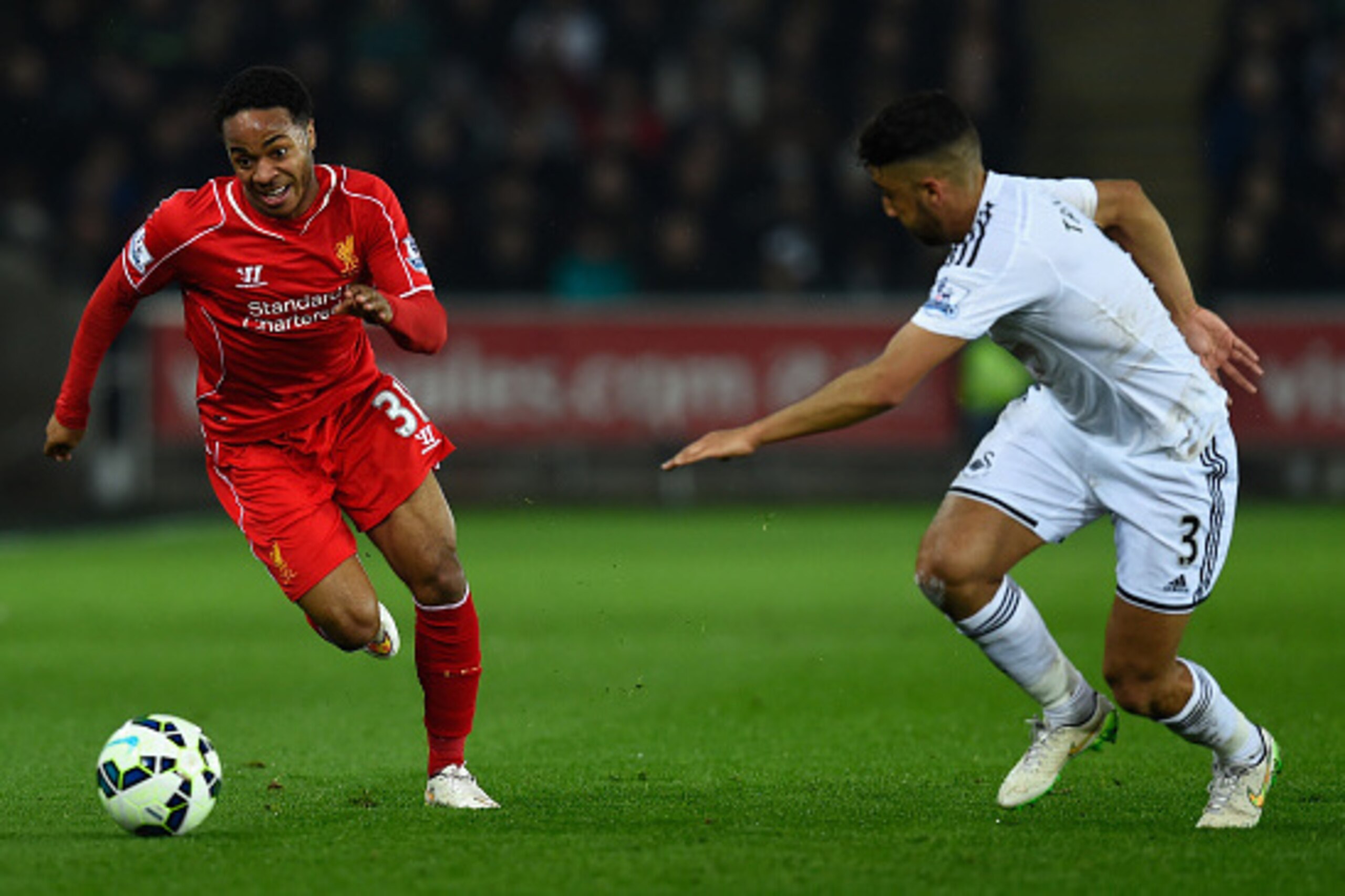 SWANSEA, WALES - MARCH 16: Liverpool player Raheem Sterling (l) takes on Neil Taylor of Swansea during the Barclays Premiership match between Swansea City and Liverpool at Liberty Stadium on March 16, 2015 in Swansea, Wales. (Photo by Stu Forster/Getty SWANSEA, WALES - MARCH 16: Liverpool player Raheem Sterling (l) takes on Neil Taylor of Swansea during the Barclays Premiership match between Swansea City and Liverpool at Liberty Stadium on March 16, 2015 in Swansea, Wales. (Photo by Stu Forster/Getty