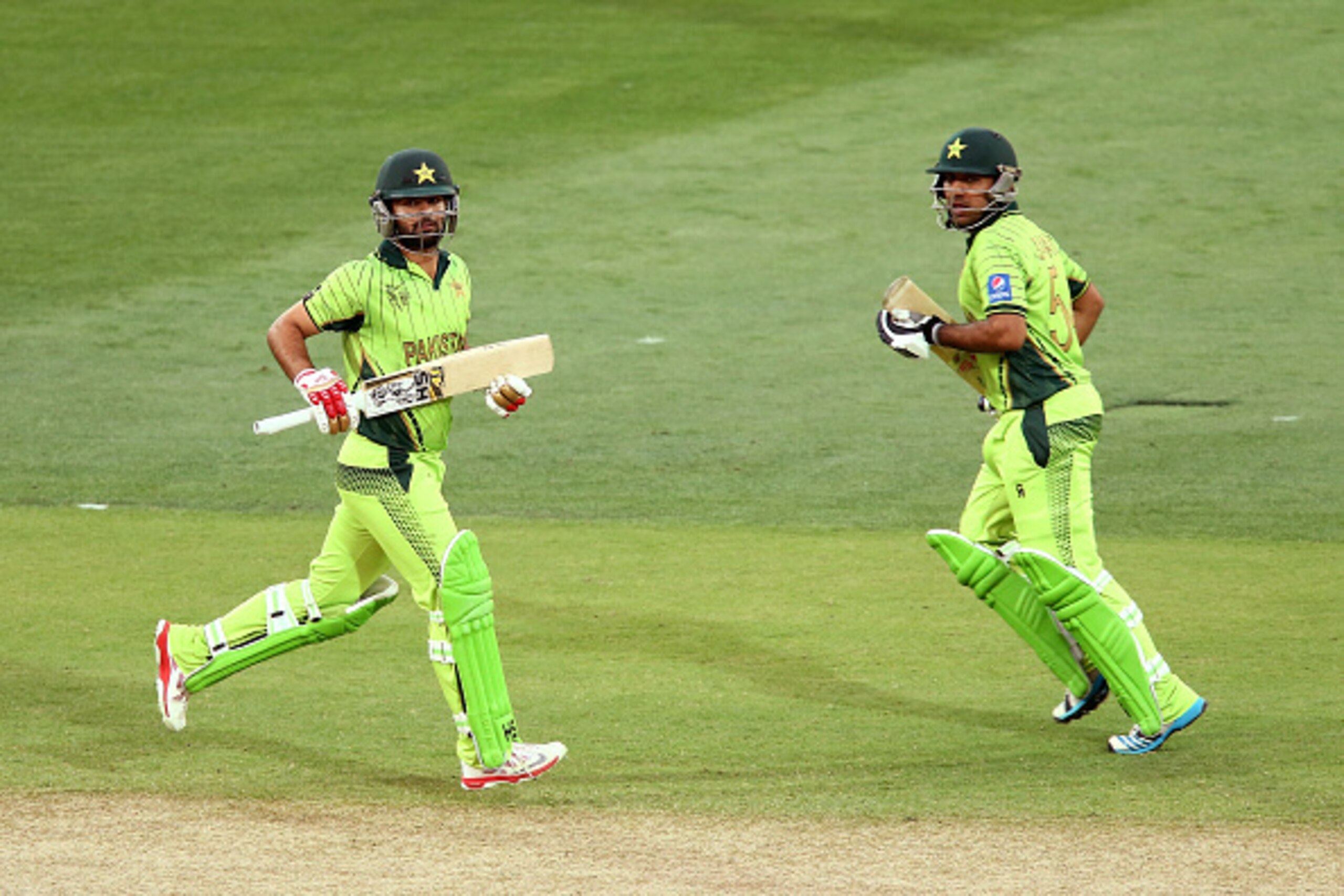 ADELAIDE, AUSTRALIA - MARCH 15:  Ahmad Shahzad and Sarfaraz Ahmed of Pakistan run between the wickets during the 2015 ICC Cricket World Cup match between Pakistan and Ireland at Adelaide Oval on March 15, 2015 in Adelaide, Australia.  (Photo by Morne de K