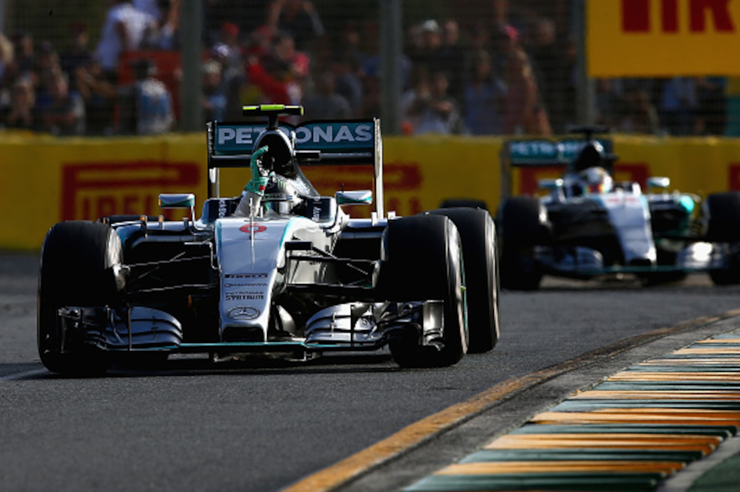 MELBOURNE, AUSTRALIA - MARCH 15:  Nico Rosberg of Germany and Mercedes GP waves to the crowd in front of Lewis Hamilton of Great Britain and Mercedes GP after the Australian Formula One Grand Prix at Albert Park on March 15, 2015 in Melbourne, Australia. 