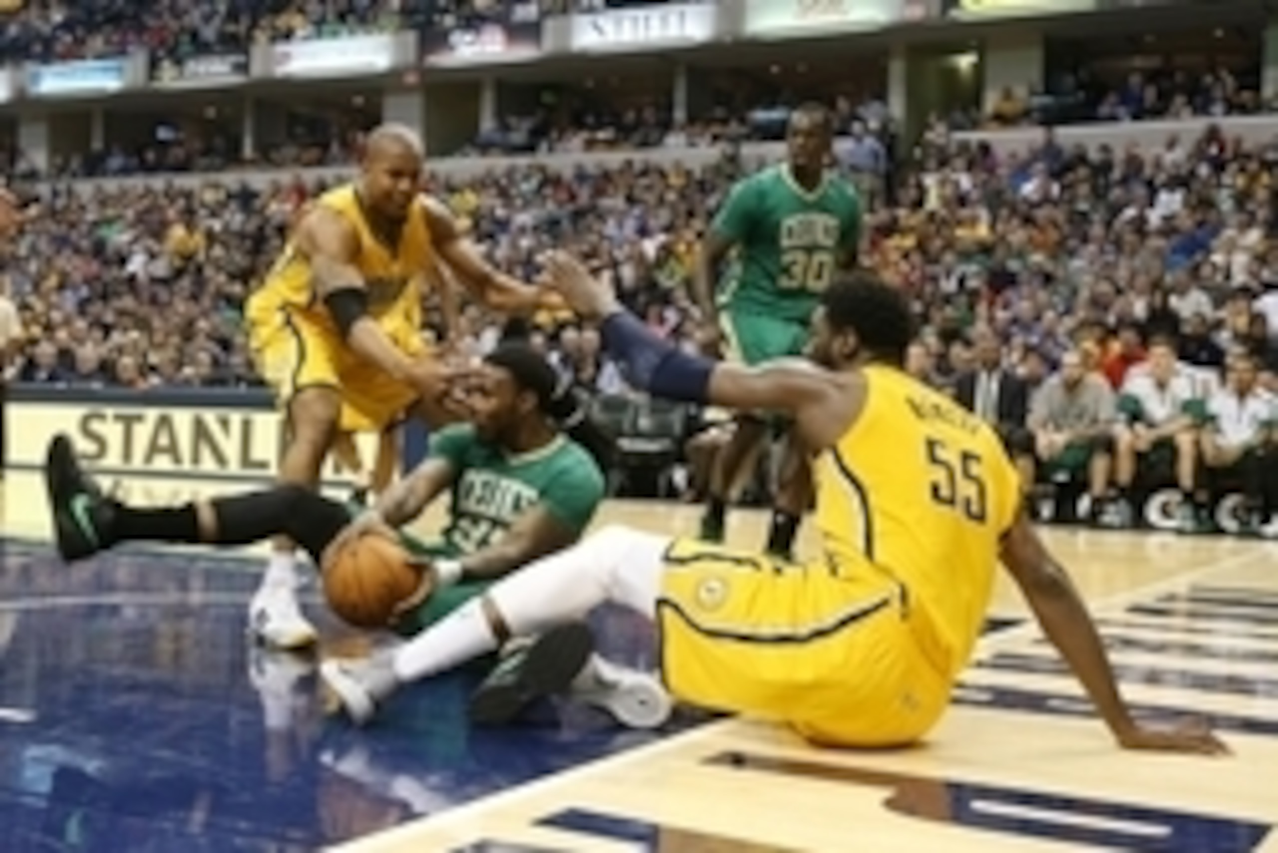 Mar 14, 2015; Indianapolis, IN, USA; Boston Celtics forward Jae Crowder (99) makes a pass from the ground against Indiana Pacers forward David West and center Roy Hibbert (55) at Bankers Life Fieldhouse. Boston defeats Indiana 93-89. Mandatory Credit: Bri