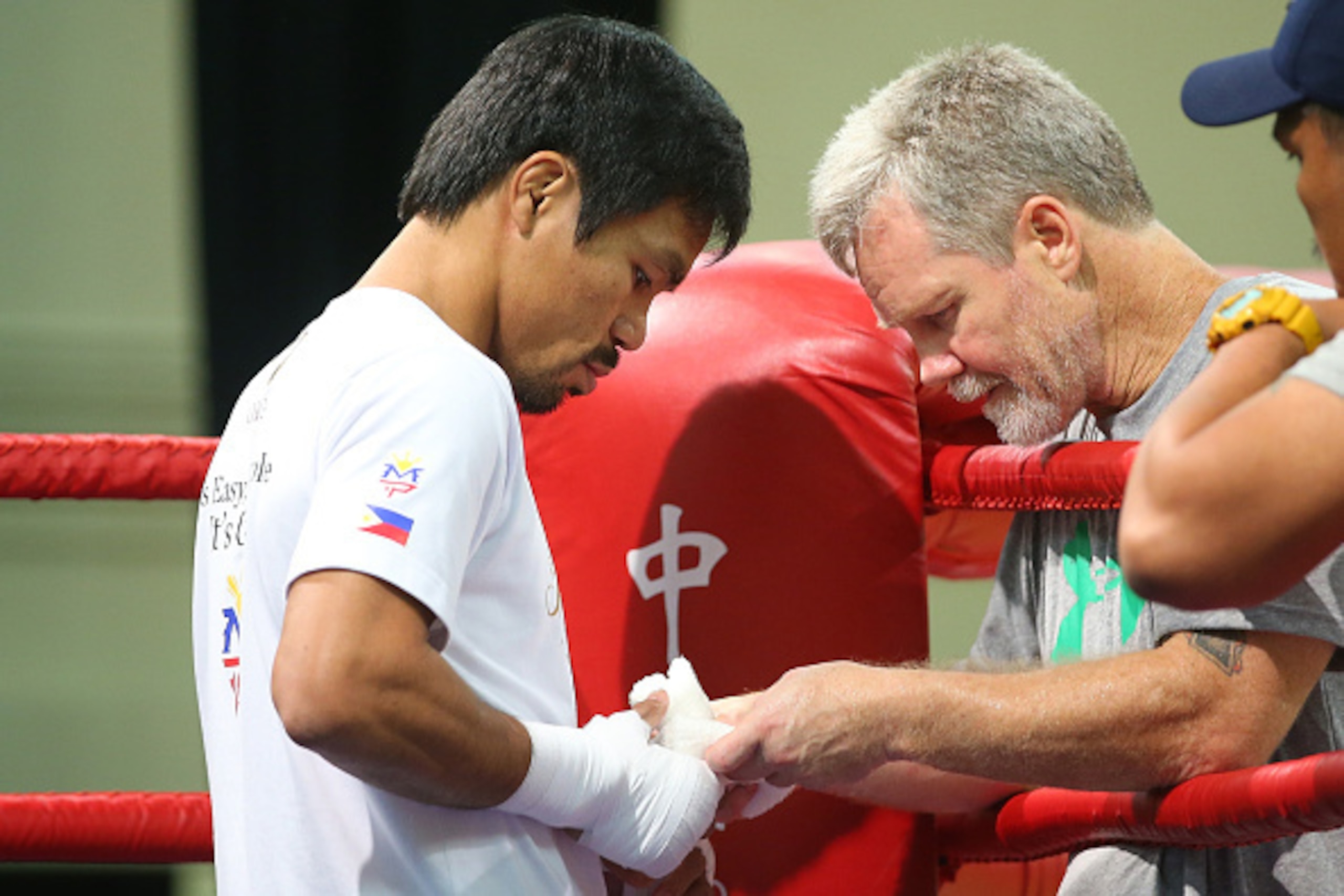 MACAU - NOVEMBER 21:  Manny Pacquiao talks with trainer Freddie Roach during a workout session at The Venetianon November 21, 2014 in Macau, Macau.  (Photo by Chris Hyde/Getty Images)