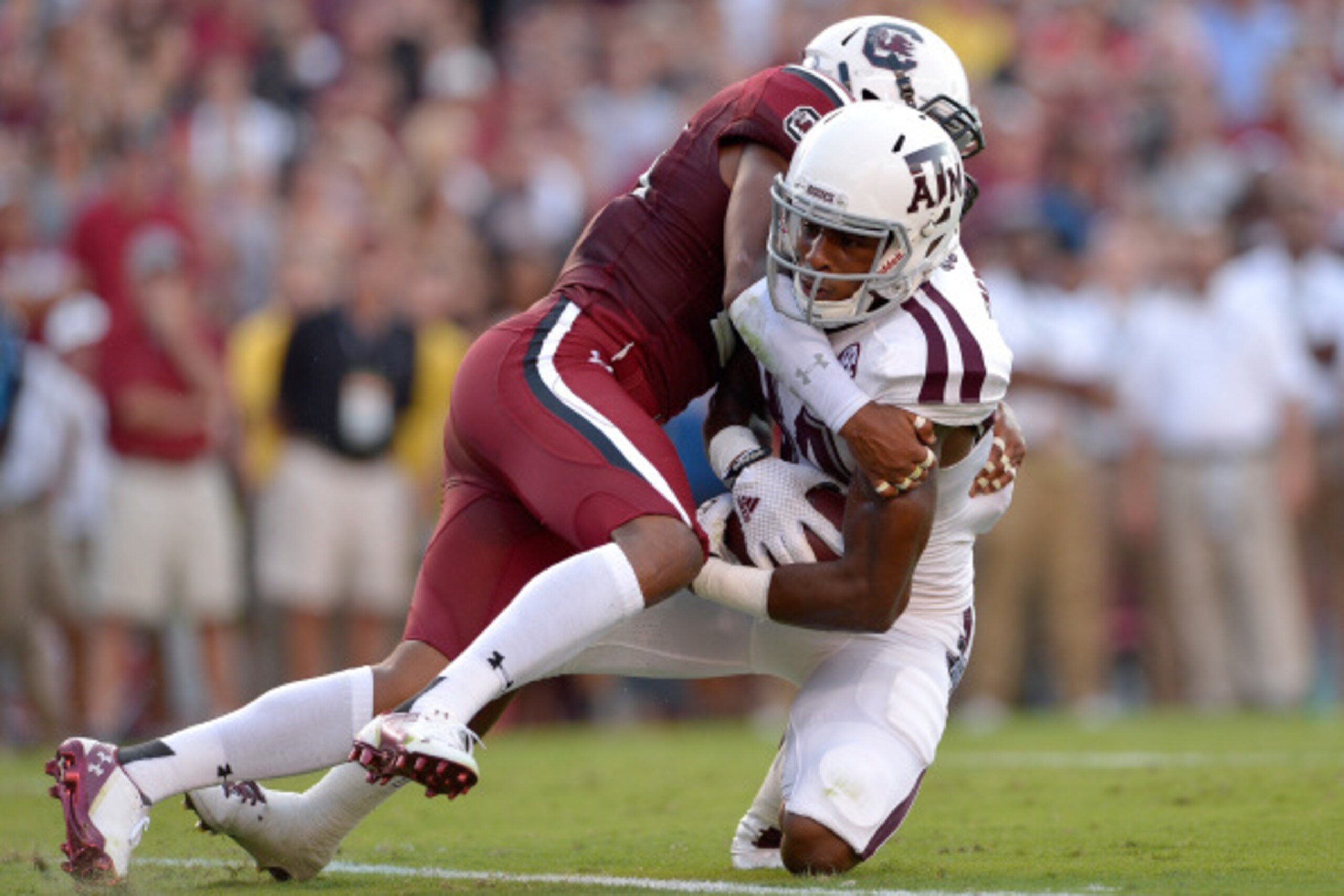 COLUMBIA, SC - AUGUST 28: T.J. Gurley #20 of the South Carolina Gamecocks stops Malcome Kennedy #84 of the Texas A&M Aggies short of the goal line during their game at Williams-Brice Stadium on August 28, 2014 in Columbia, South Carolina. (Photo by Grant 