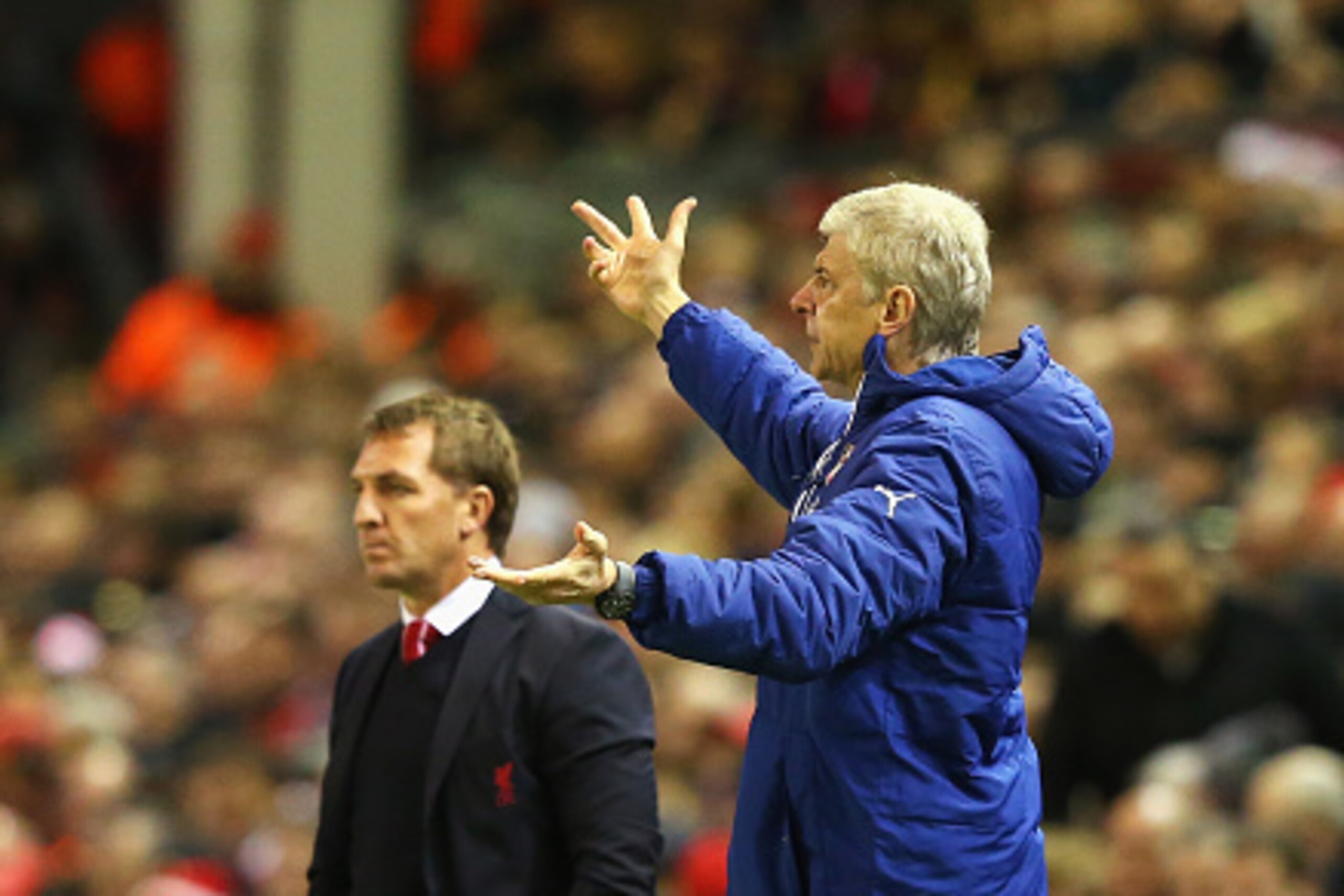 LIVERPOOL, ENGLAND - DECEMBER 21: Arsene Wenger, manager of Arsenal gestures with Brendan Rodgers, manager of Liverpool during the Barclays Premier League match between Liverpool and Arsenal at Anfield on December 21, 2014 in Liverpool, England.  (Photo b