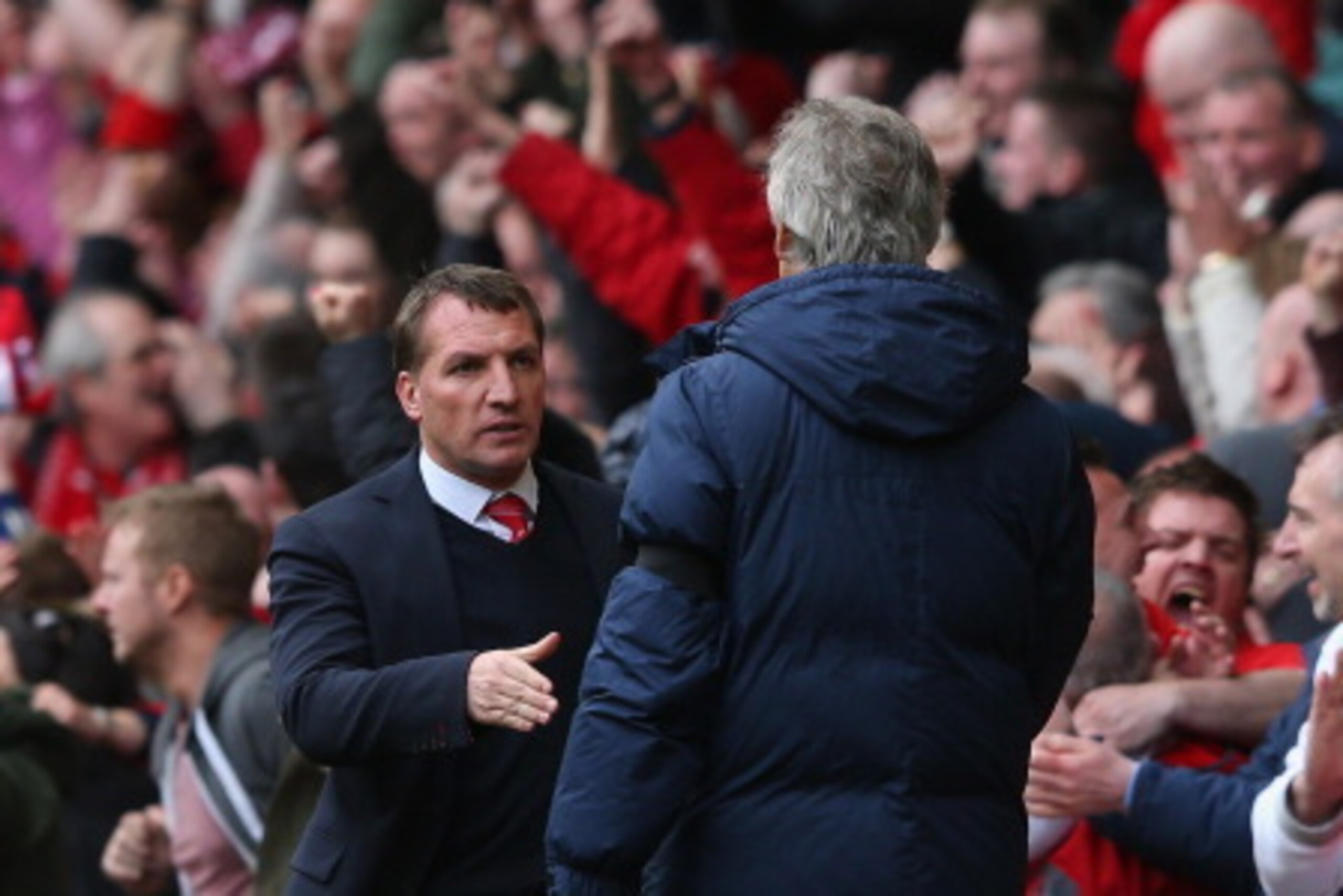 LIVERPOOL, ENGLAND - APRIL 13:  Manchester City Manager Manuel Pellegrini (R) shakes hands with Liverpool Manager Brendan Rodgers at the end of the Barclays Premier League match between Liverpool and Manchester City at Anfield on April 13, 2014 in Liverpo