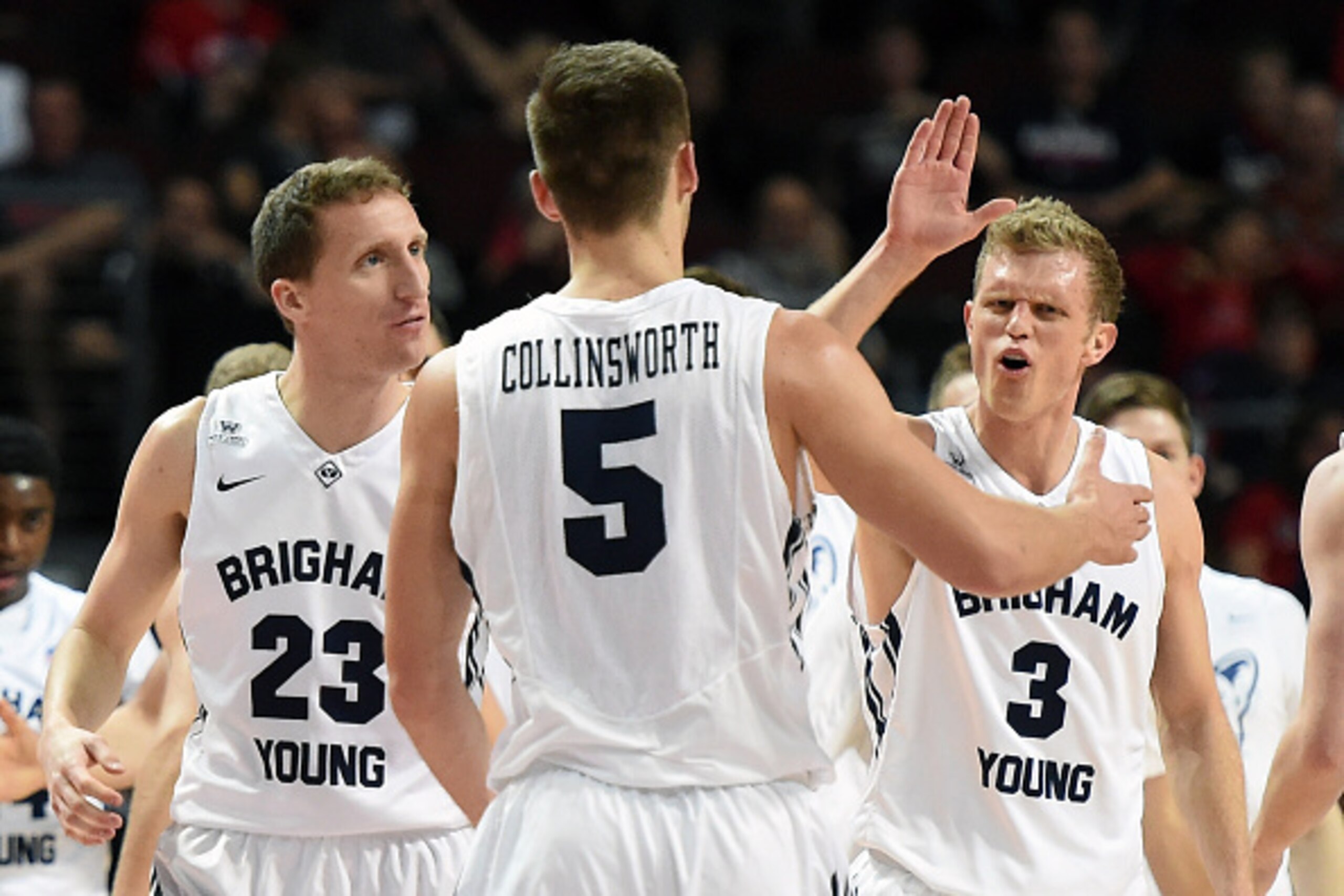 LAS VEGAS, NV - MARCH 09:  Skyler Halford #23, Kyle Collinsworth #5 and Tyler Haws #3 of the Brigham Young Cougars celebrate on the court in the first half of a semifinal game of the West Coast Conference Basketball tournament against the Portland Pilots 
