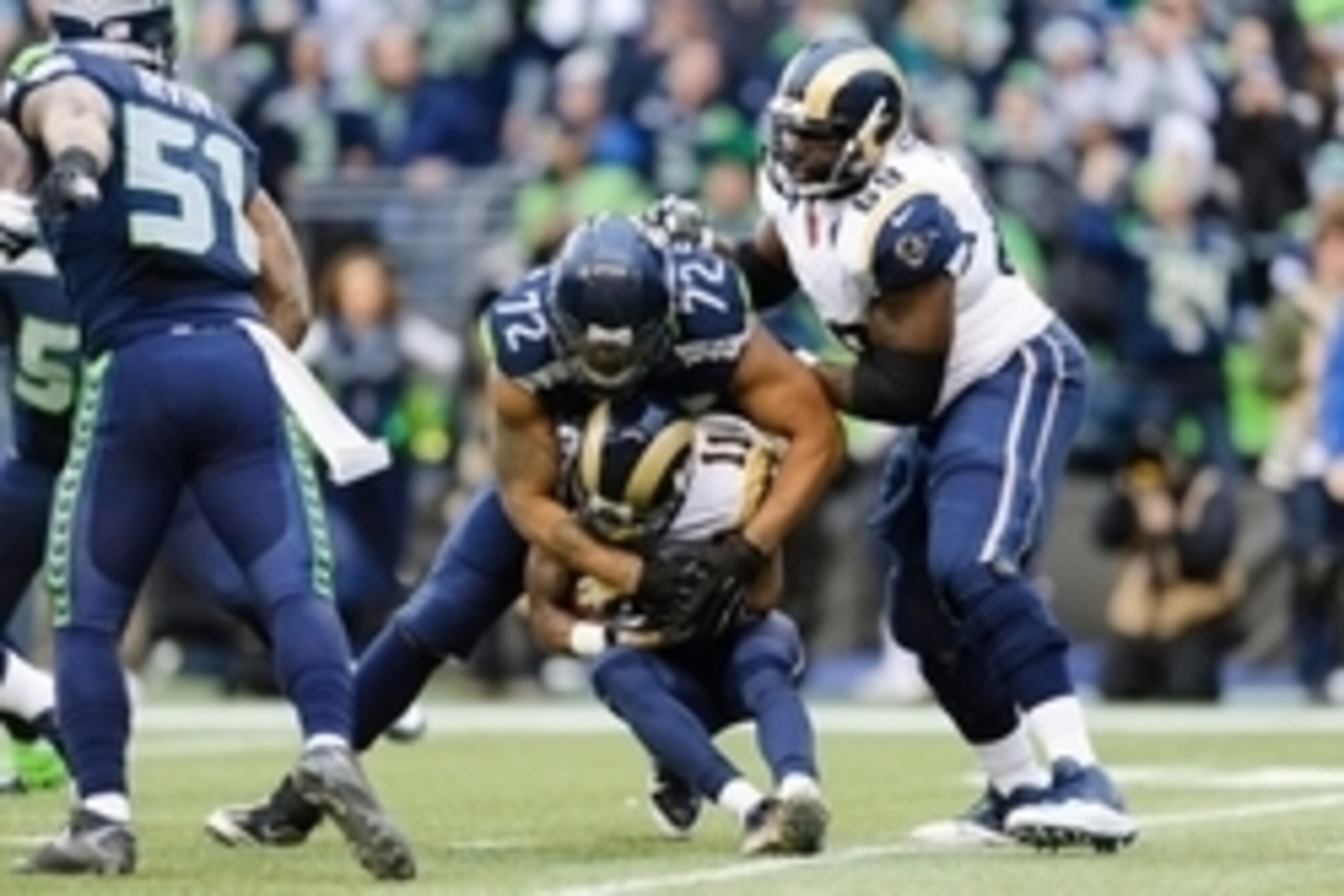 Dec 28, 2014; Seattle, WA, USA; Seattle Seahawks defensive end Michael Bennett (72) tackles St. Louis Rams wide receiver Tavon Austin (11) during the second half at CenturyLink Field. Seattle defeated St. Louis 20-6. Mandatory Credit: Steven Bisig-USA TOD