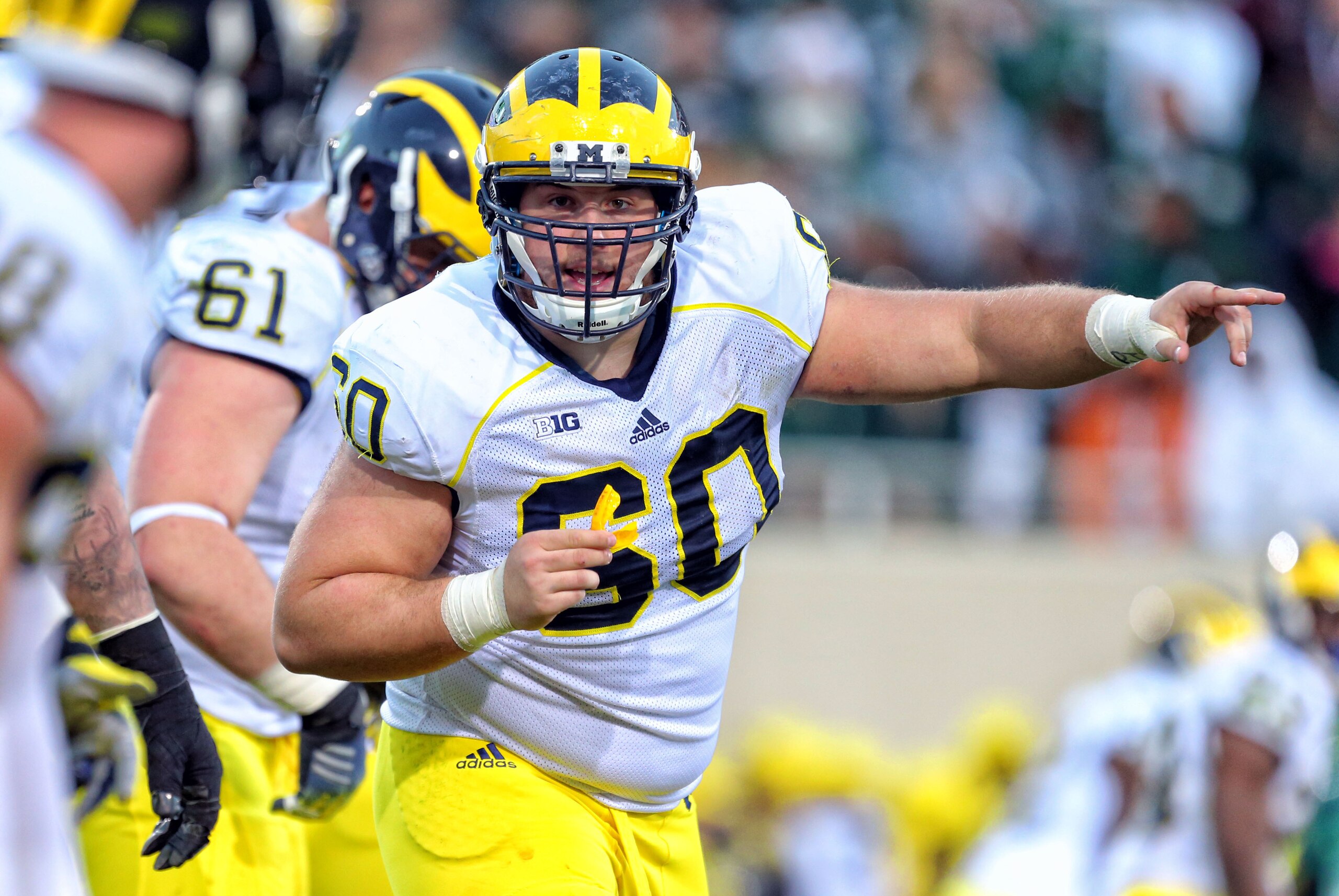 Oct 25, 2014; East Lansing, MI, USA; Michigan Wolverines offensive lineman Jack Miller (60) points to defensive line during the 2nd half of a game at Spartan Stadium.  MSU won 35-11. Mandatory Credit: Mike Carter-USA TODAY Sports
