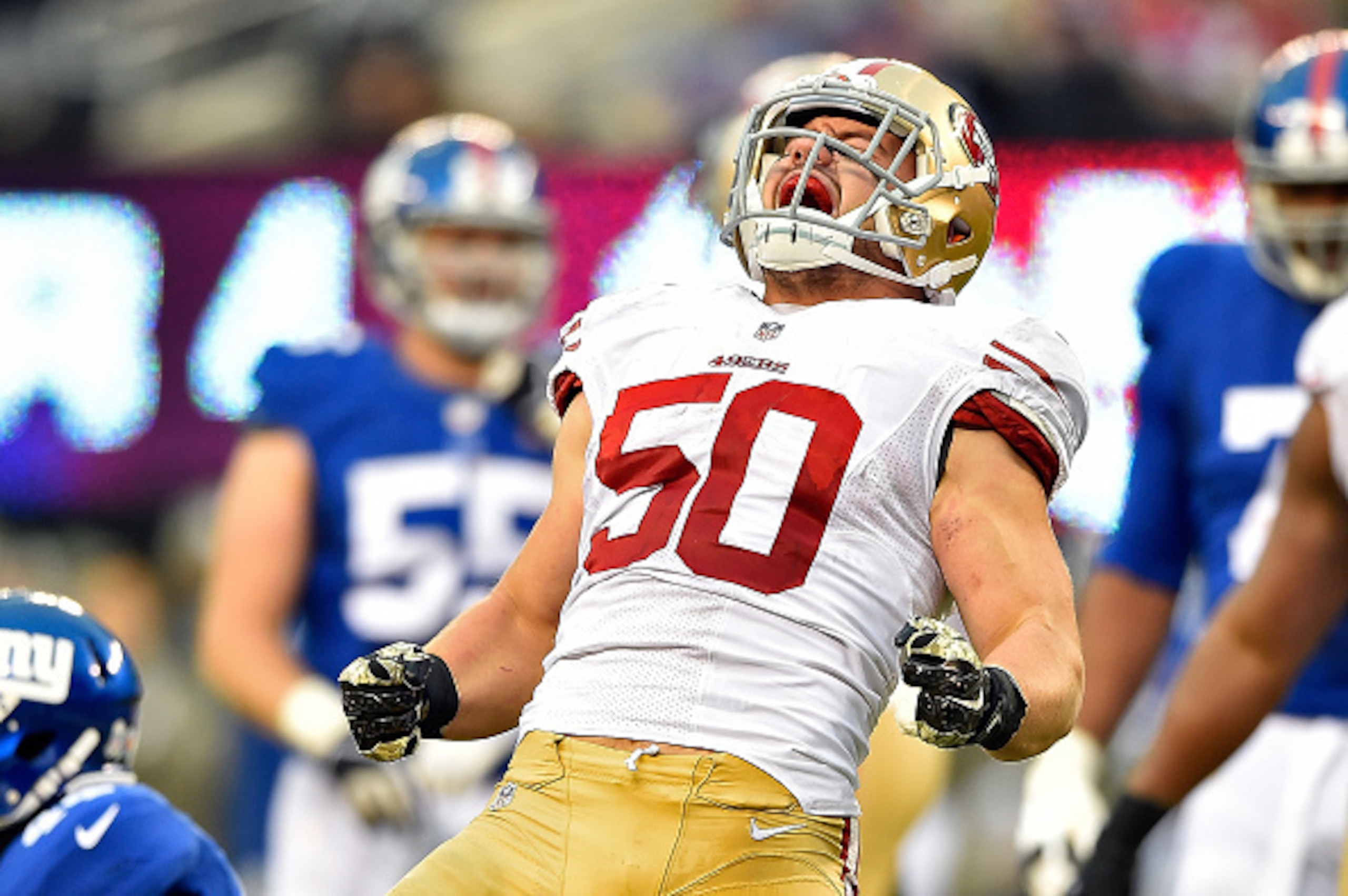 EAST RUTHERFORD, NJ - NOVEMBER 16:   Chris Borland #50 of the San Francisco 49ers celebrates after a tackle against the New York Giants in the fourth quarter at MetLife Stadium on November 16, 2014 in East Rutherford, New Jersey.  (Photo by Al Bello/Getty