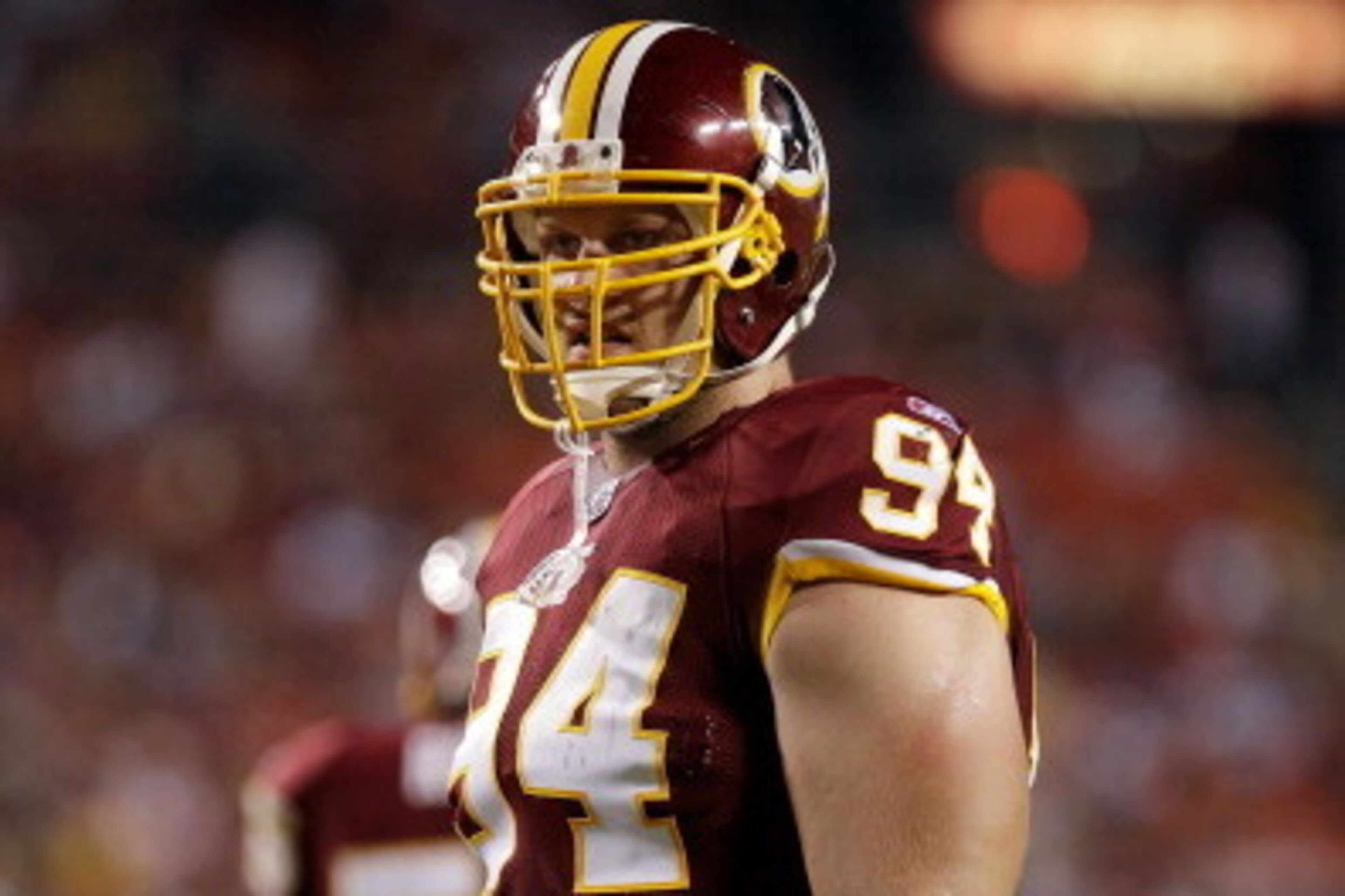 LANDOVER, MD - SEPTEMBER 01:  Adam Carriker #94 of the Washington Redskins  waits for play to resume against the Tampa Bay Buccaneers during the first half of a preseason game at FedExField on September 1, 2011 in Landover, Maryland.  (Photo by Rob Carr/G