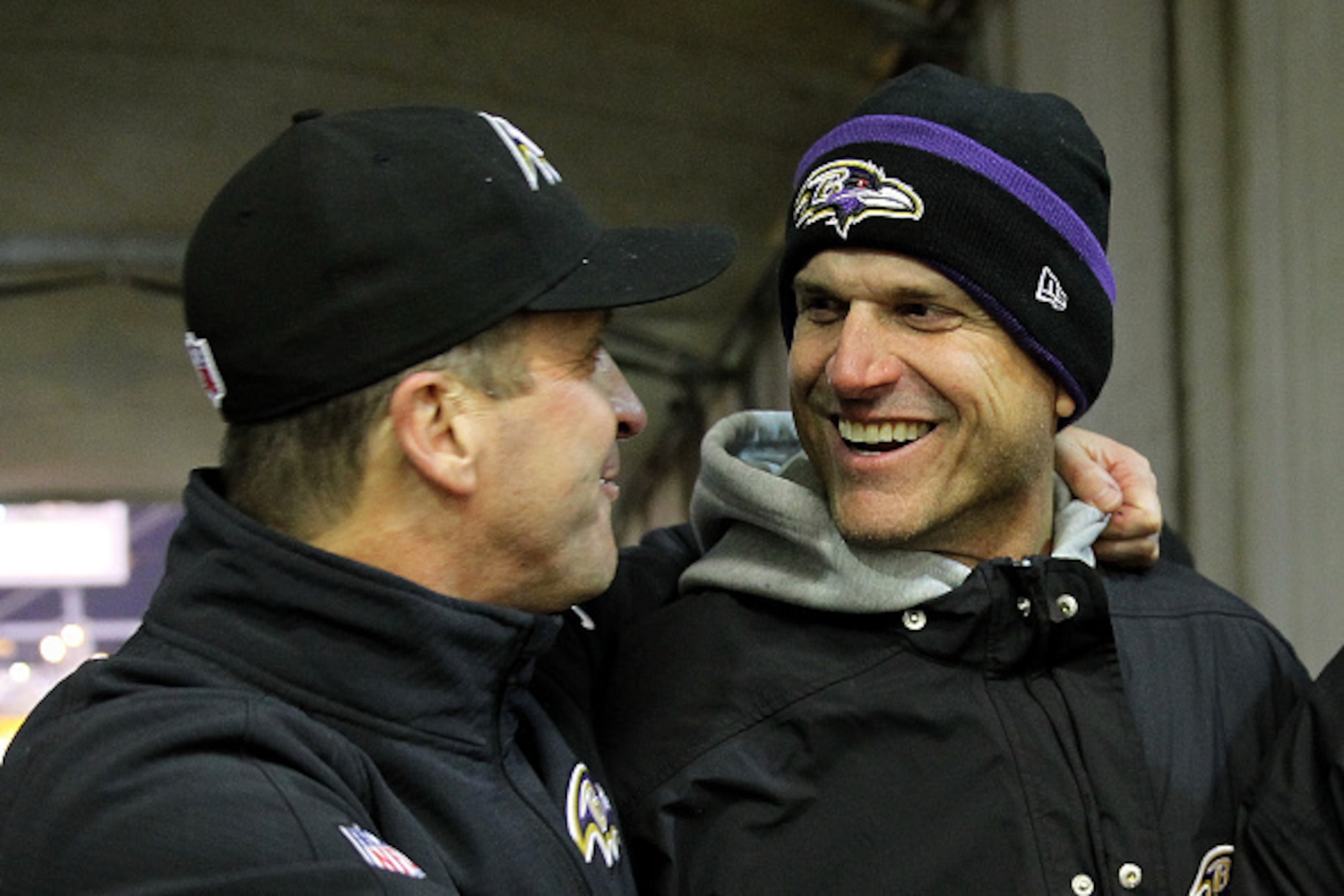 PITTSBURGH, PA - JANUARY 03: Michigan coach Jim Harbaugh (R) celebrates with his brother, head coach John Harbaugh (L) of the Baltimore Ravens after the Ravens defeated the Pittsburgh Steelers 30-17 in their AFC Wild Card game at Heinz Field on January 3,