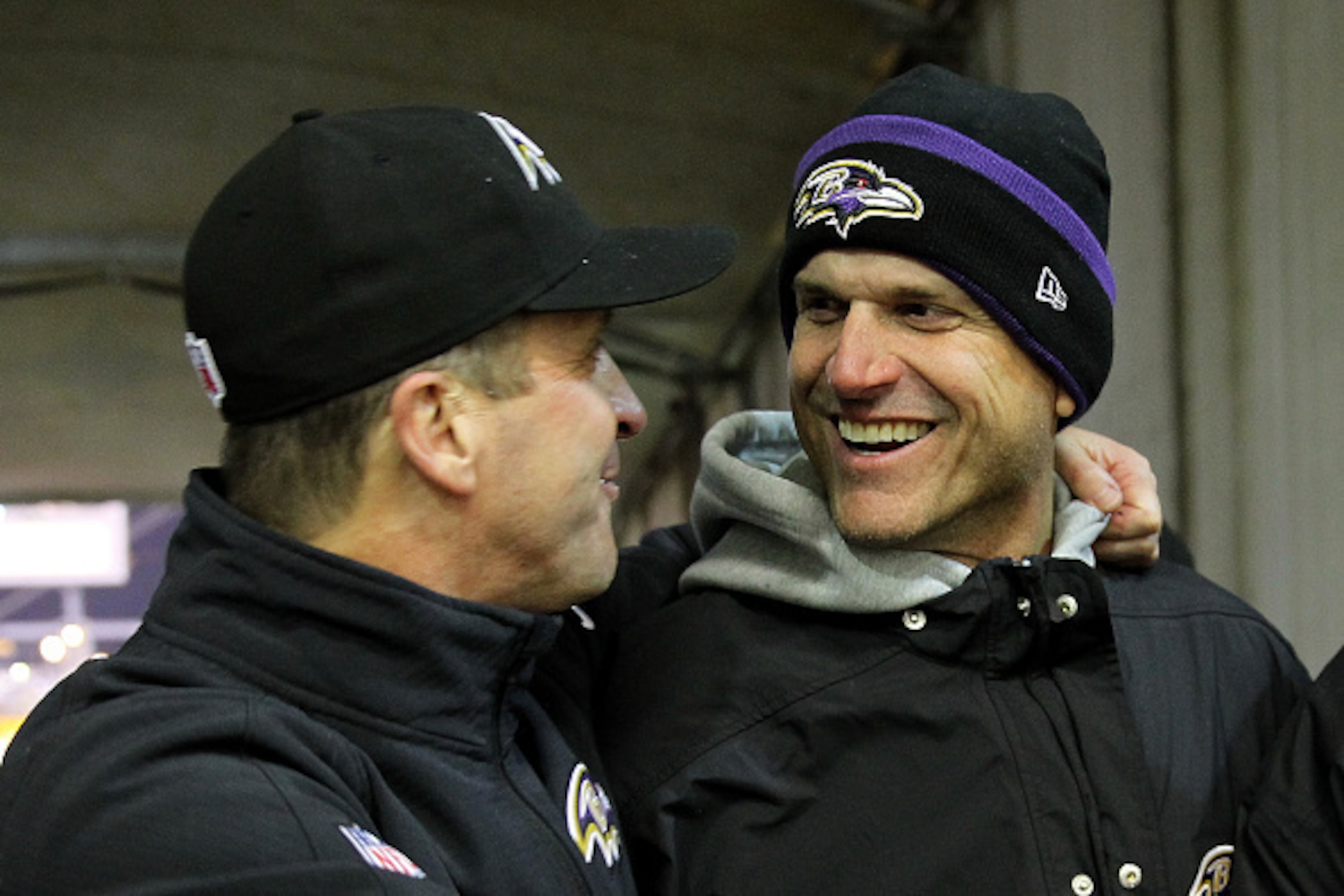 PITTSBURGH, PA - JANUARY 03: Michigan coach Jim Harbaugh (R) celebrates with his brother, head coach John Harbaugh (L) of the Baltimore Ravens after the Ravens defeated the Pittsburgh Steelers 30-17 in their AFC Wild Card game at Heinz Field on January 3, PITTSBURGH, PA - JANUARY 03: Michigan coach Jim Harbaugh (R) celebrates with his brother, head coach John Harbaugh (L) of the Baltimore Ravens after the Ravens defeated the Pittsburgh Steelers 30-17 in their AFC Wild Card game at Heinz Field on January 3,
