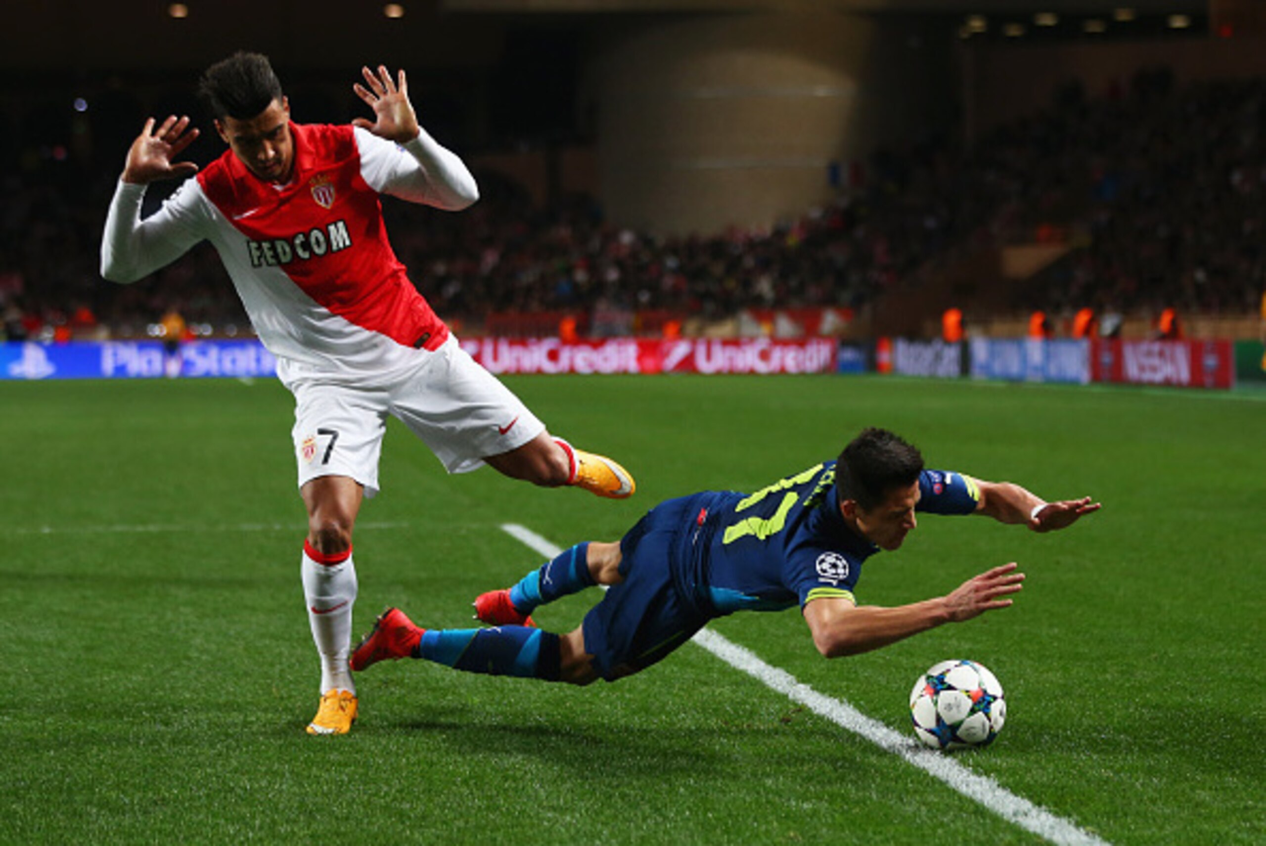 MONACO - MARCH 17:  Alexis Sanchez of Arsenal is challenged by Nabil Dirar of Monaco during the UEFA Champions League round of 16 second leg match between AS Monaco and Arsenal at Stade Louis II on March 17, 2015 in Monaco, Monaco.  (Photo by Michael Stee