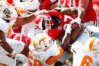 ATHENS, GA - SEPTEMBER 27:  Owen Williams #58 of the Tennessee Volunteers is flagged for a facemask penalty as Williams, Derek Barnett #9 and Todd Kelly Jr. #6 of the Tennessee Volunteers tackle Nick Chubb #27 of the Georgia Bulldogs at Sanford Stadium on