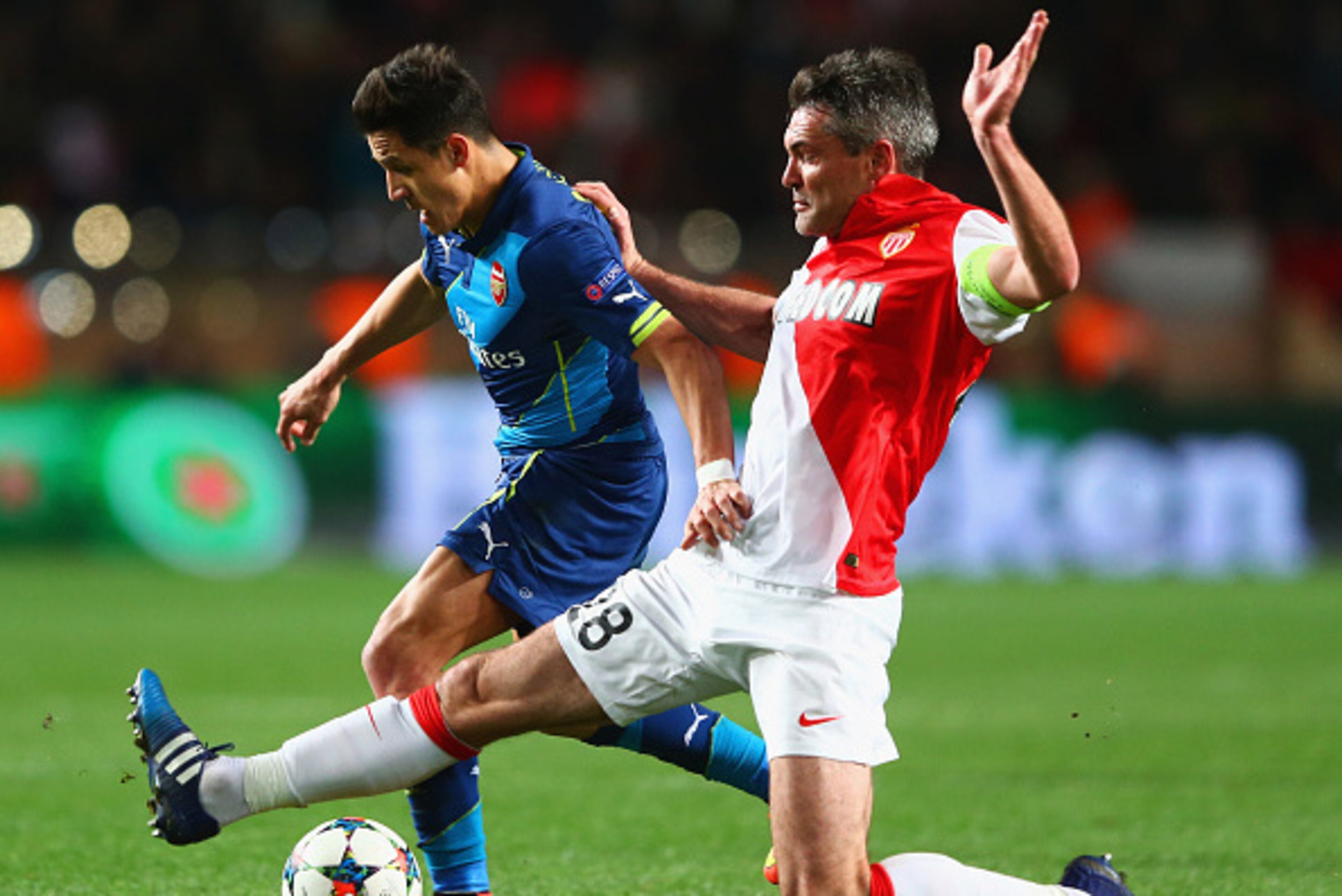 MONACO - MARCH 17:  Alexis Sanchez of Arsenal takes on Jeremy Toulalan of Monaco during the UEFA Champions League round of 16 second leg match between AS Monaco and Arsenal at Stade Louis II on March 17, 2015 in Monaco, Monaco.  (Photo by Michael Steele/G