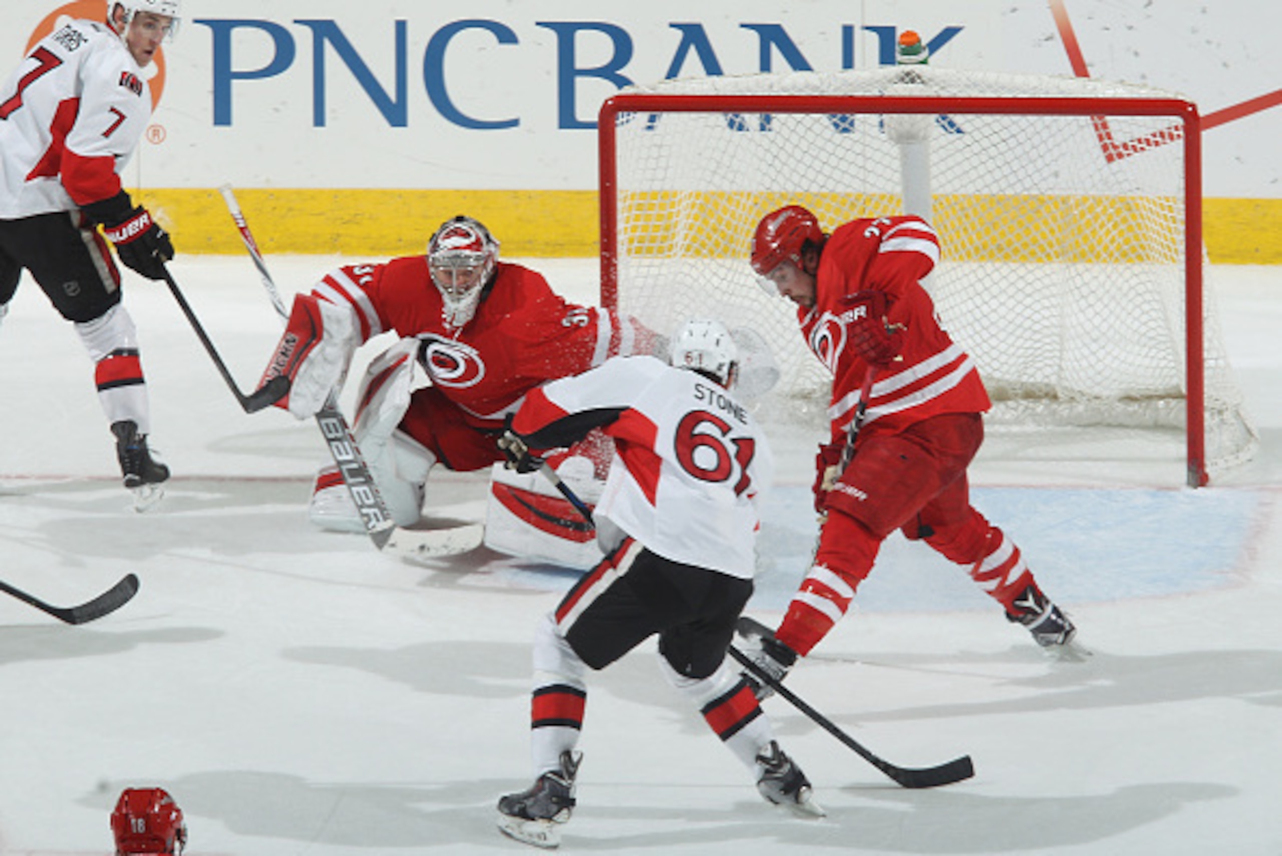 RALEIGH, NC - MARCH 17: Kyle Turris #7 of the Ottawa Senators passes the puck to teammate Mark Stone #61 who scores the game winning goal in overtime to defeat the Carolina Hurricanes during their NHL game at PNC Arena on March 17, 2015 in Raleigh, North RALEIGH, NC - MARCH 17: Kyle Turris #7 of the Ottawa Senators passes the puck to teammate Mark Stone #61 who scores the game winning goal in overtime to defeat the Carolina Hurricanes during their NHL game at PNC Arena on March 17, 2015 in Raleigh, North