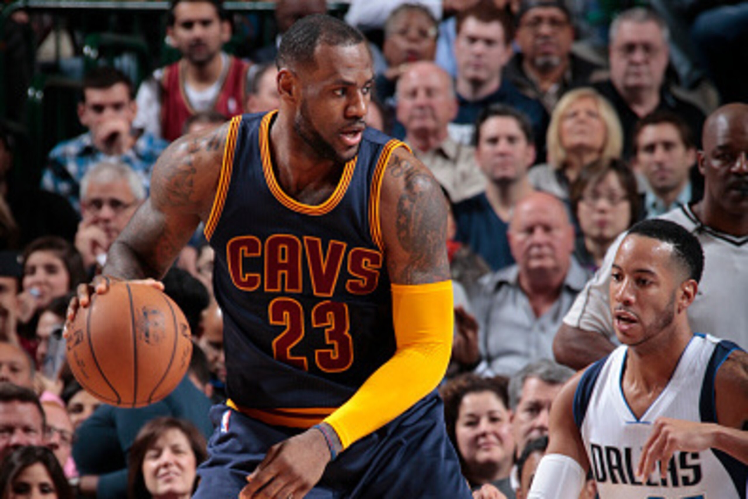 DALLAS, TX - MARCH 10:   LeBron James #23 of the Cleveland Cavaliers handles the ball against Devin Harris #20 of the Dallas Mavericks on March 10, 2015 at the American Airlines Center in Dallas, Texas. NOTE TO USER: User expressly acknowledges and agrees