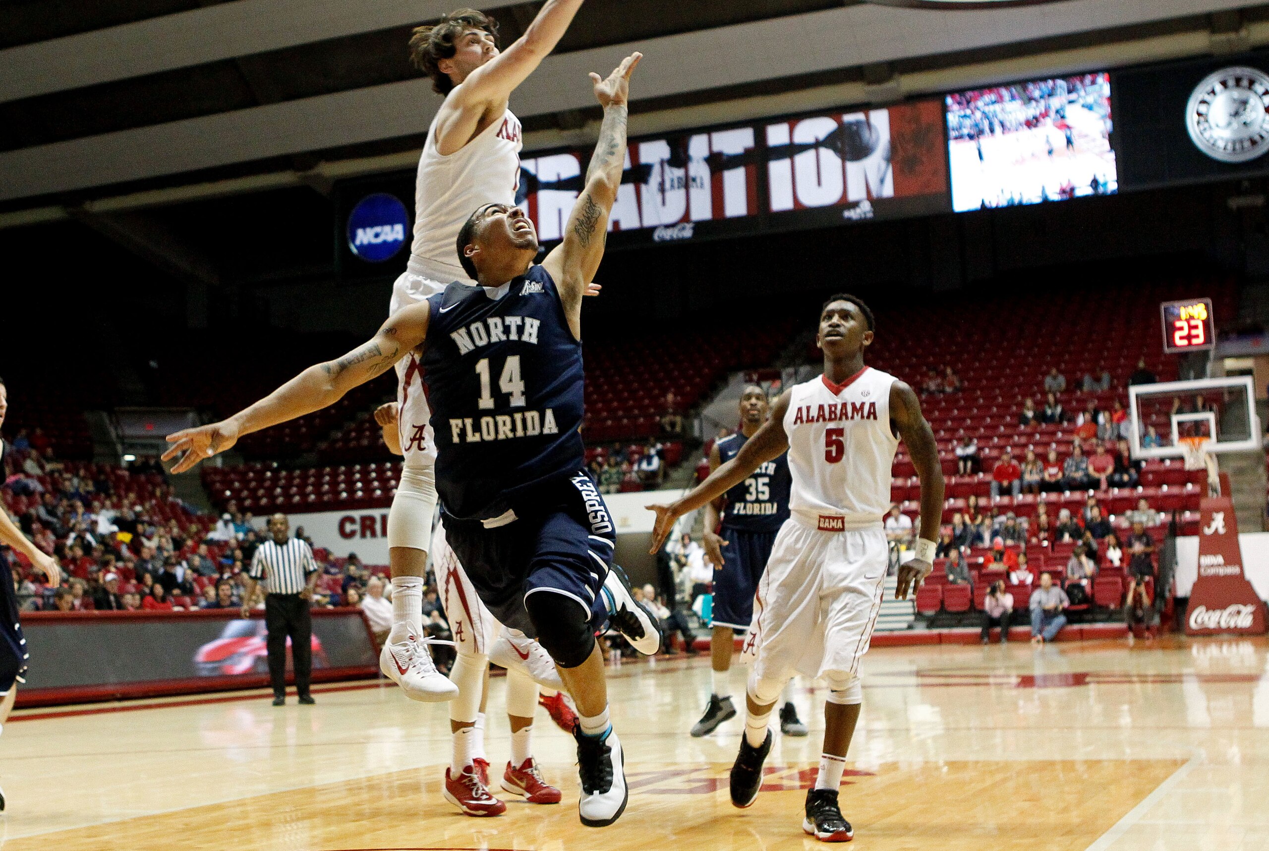 Jan 2, 2015; Tuscaloosa, AL, USA; Alabama Crimson Tide guard/forward Riley Norris (1) knocks away the ball from North Florida Ospreys guard Dallas Moore (14) at Coleman Coliseum. Mandatory Credit: Marvin Gentry-USA TODAY Sports
