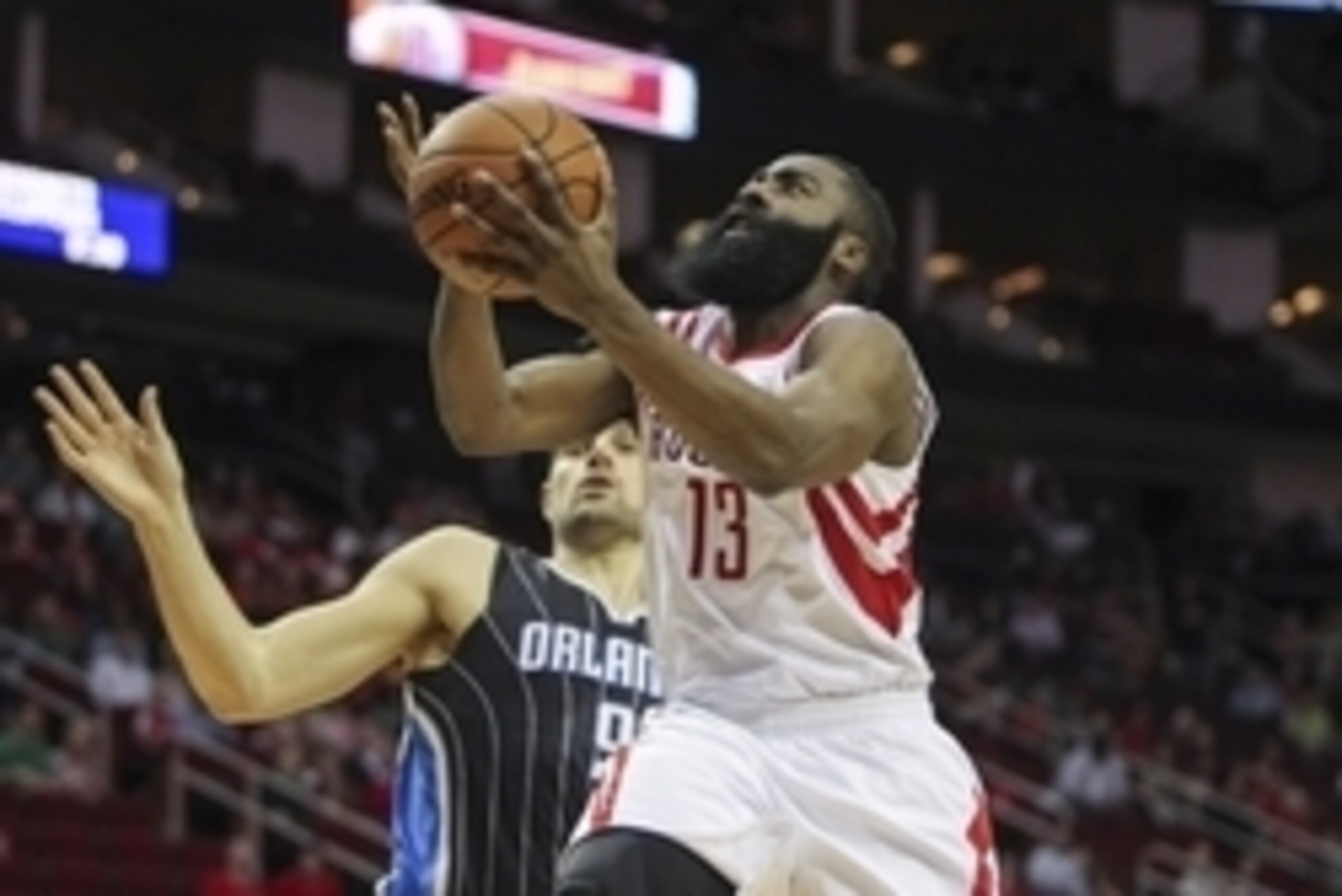 Mar 17, 2015; Houston, TX, USA; Houston Rockets guard James Harden (13) drives to the basket during the first quarter as Orlando Magic center Nikola Vucevic (9) defends at Toyota Center. Mandatory Credit: Troy Taormina-USA TODAY Sports