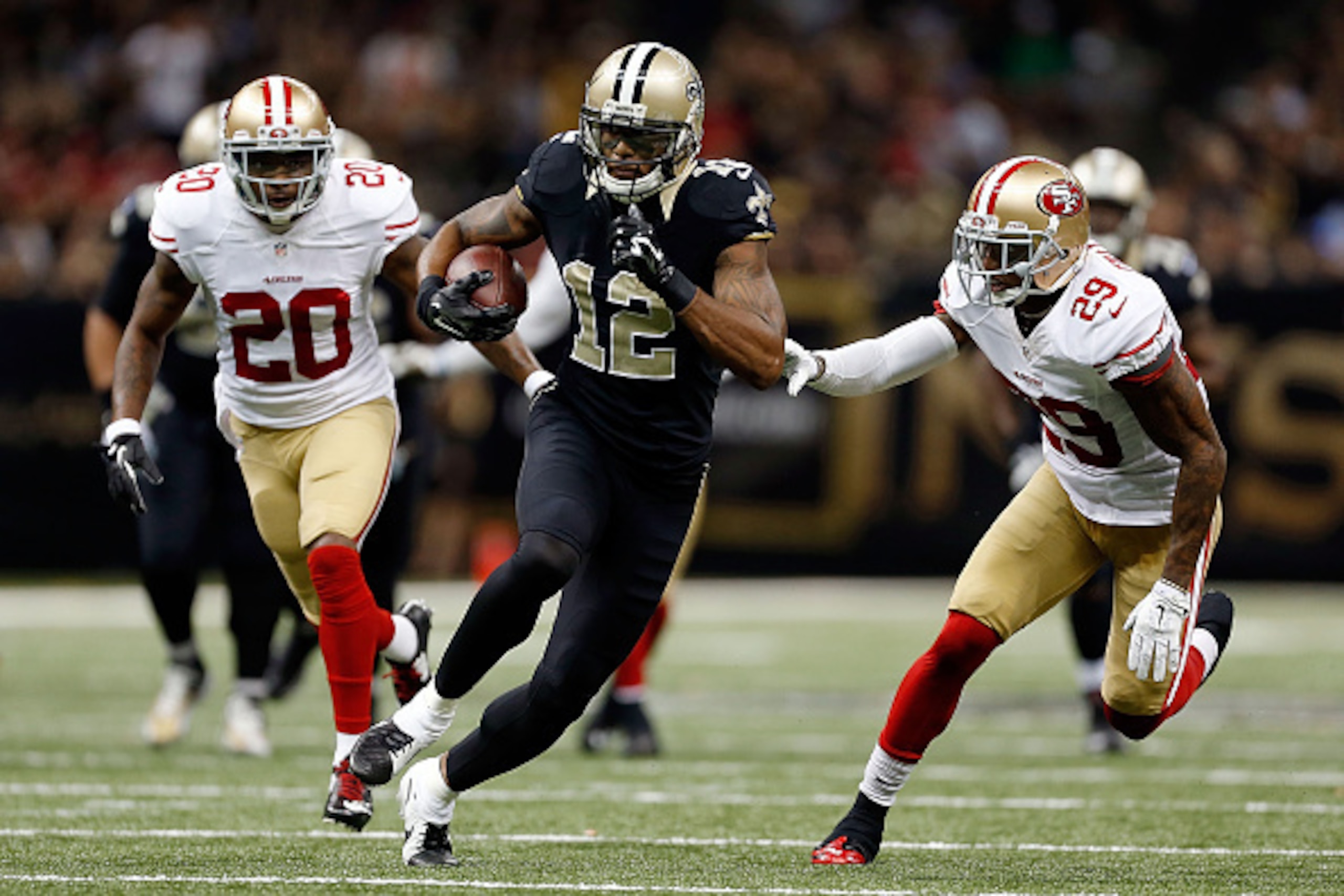 NEW ORLEANS, LA - NOVEMBER 09:  Marques Colston #12 of the New Orleans Saints is pursued by Perrish Cox #20 and Chris Culliver #29 of the San Francisco 49ers during the fourth quarter of a game at the Mercedes-Benz Superdome on November 9, 2014 in New Orl