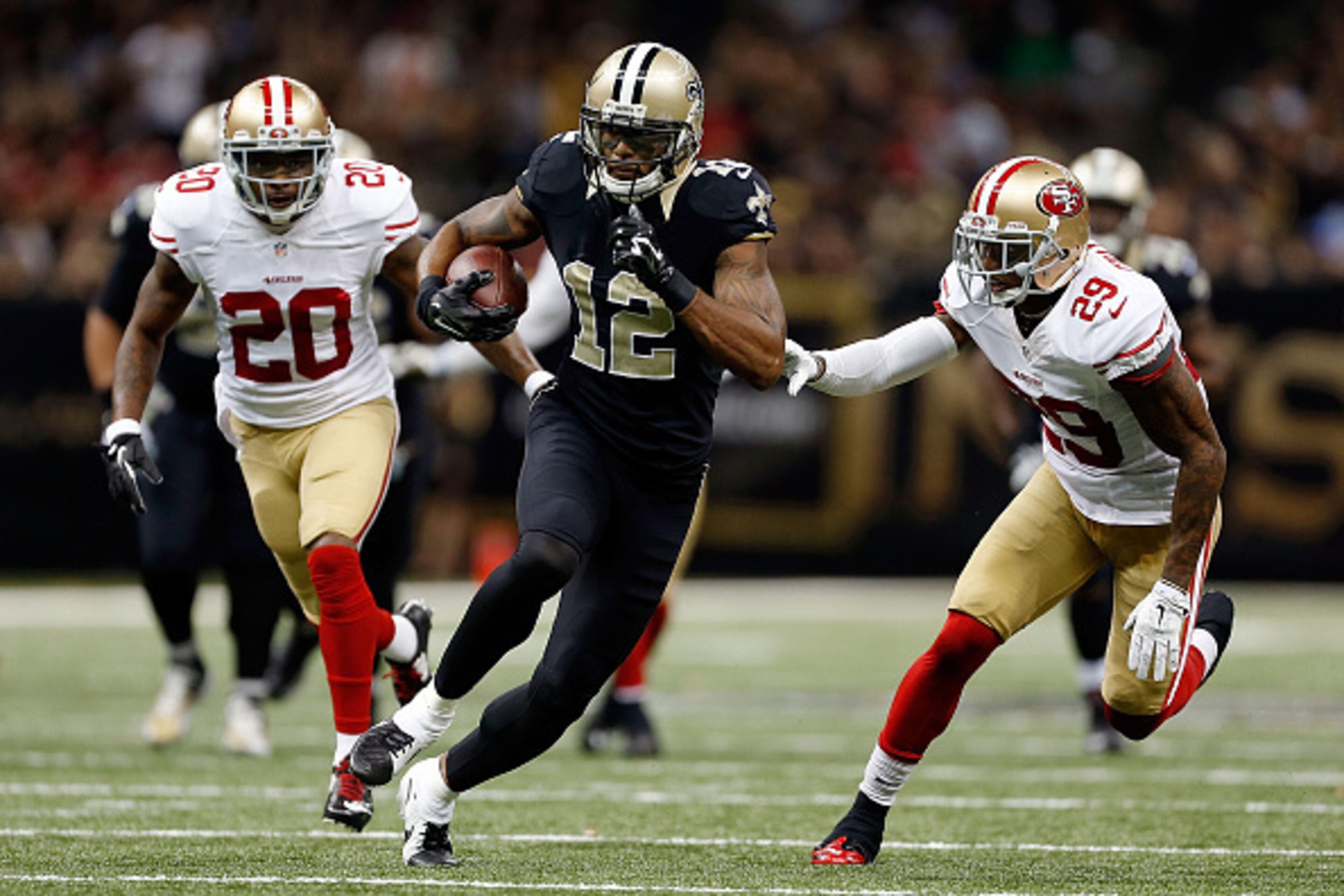 NEW ORLEANS, LA - NOVEMBER 09:  Marques Colston #12 of the New Orleans Saints is pursued by Perrish Cox #20 and Chris Culliver #29 of the San Francisco 49ers during the fourth quarter of a game at the Mercedes-Benz Superdome on November 9, 2014 in New Orl