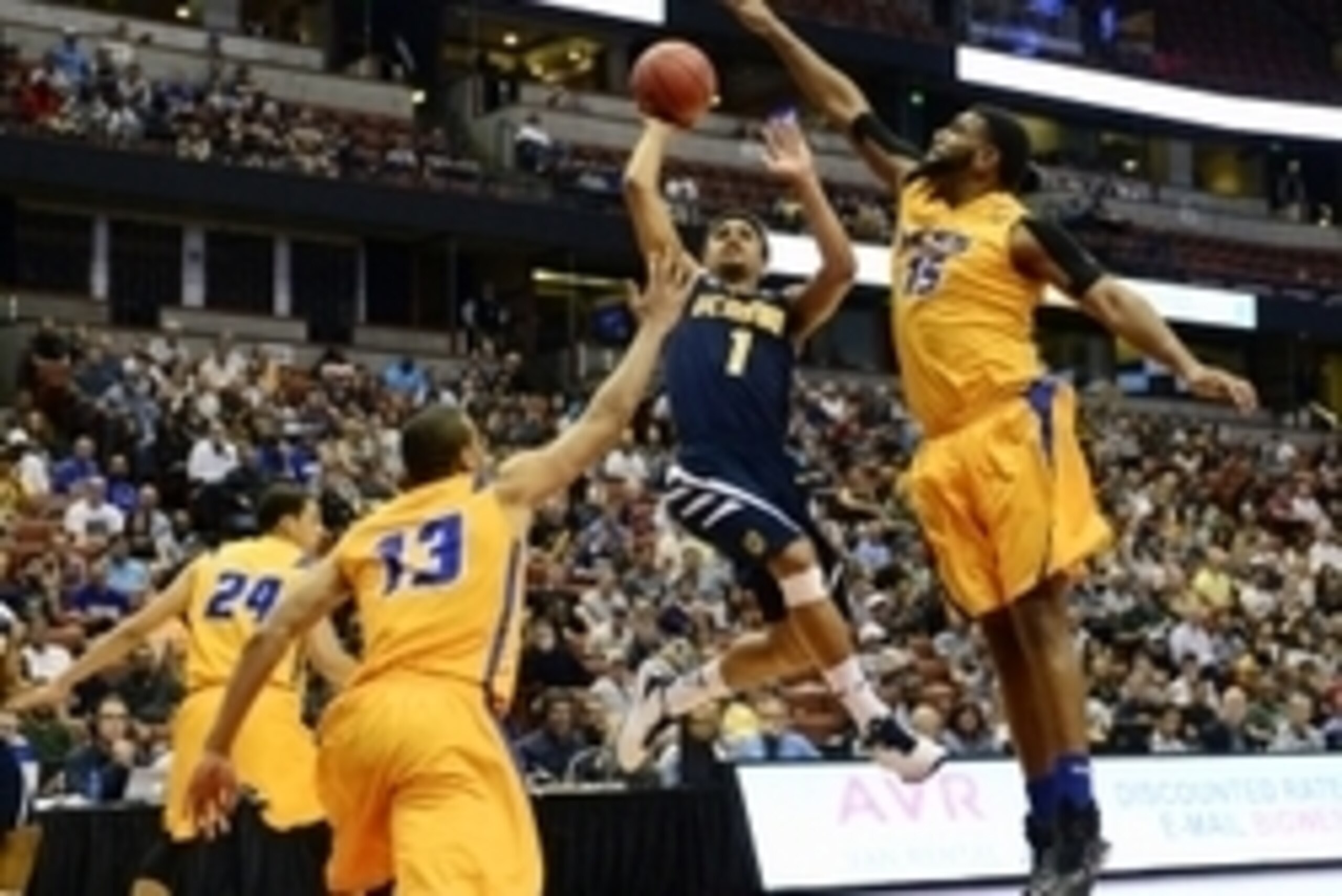 Mar 13, 2015; Anaheim, CA, USA; UC Irvine Anteaters guard Alex Young (1) attempts a shot defended by UC Santa Barbara Gauchos center Alan Williams (15) during the first half of the semifinals in the Big West Conference Tournament at Honda Center. Mandator