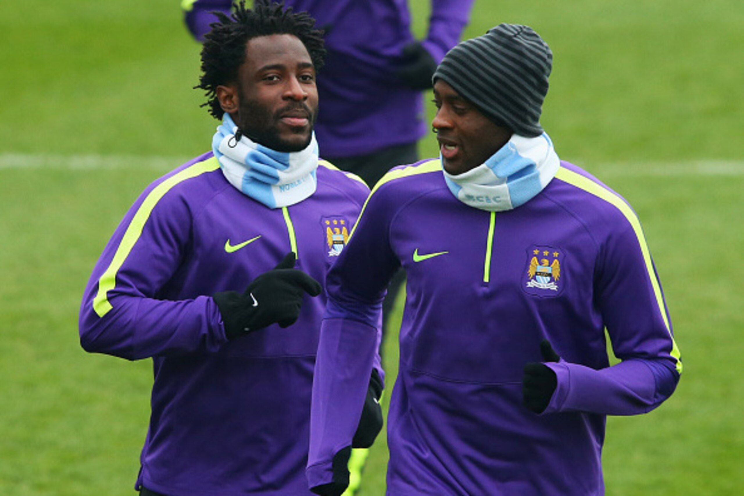 MANCHESTER, ENGLAND - MARCH 17:  Wilfred Bony (L) and Yaya Toure warm up during a Manchester City training session ahead of the UEFA Champions League round of 16 second leg match against Barcelona at Etihad Campus on March 17, 2015 in Manchester, United K