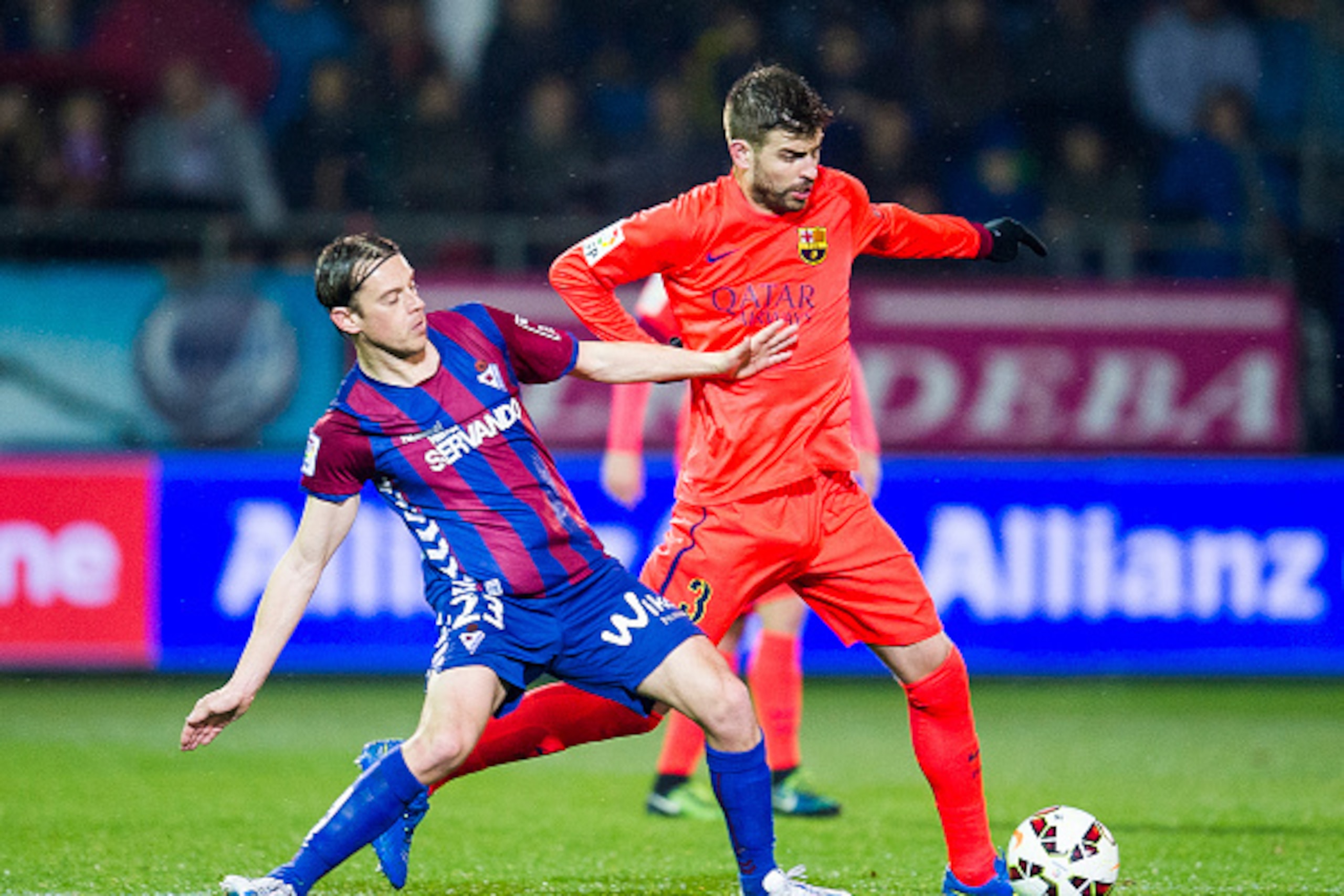 EIBAR, SPAIN - MARCH 14:  Gerard Pique of FC Barcelona duels for the ball with Javier Lara of SD Eibar during the La Liga match between SD Eibar and FC Barcelona at Ipurua Municipal Stadium on March 14, 2015 in Eibar, Spain.  (Photo by Juan Manuel Serrano