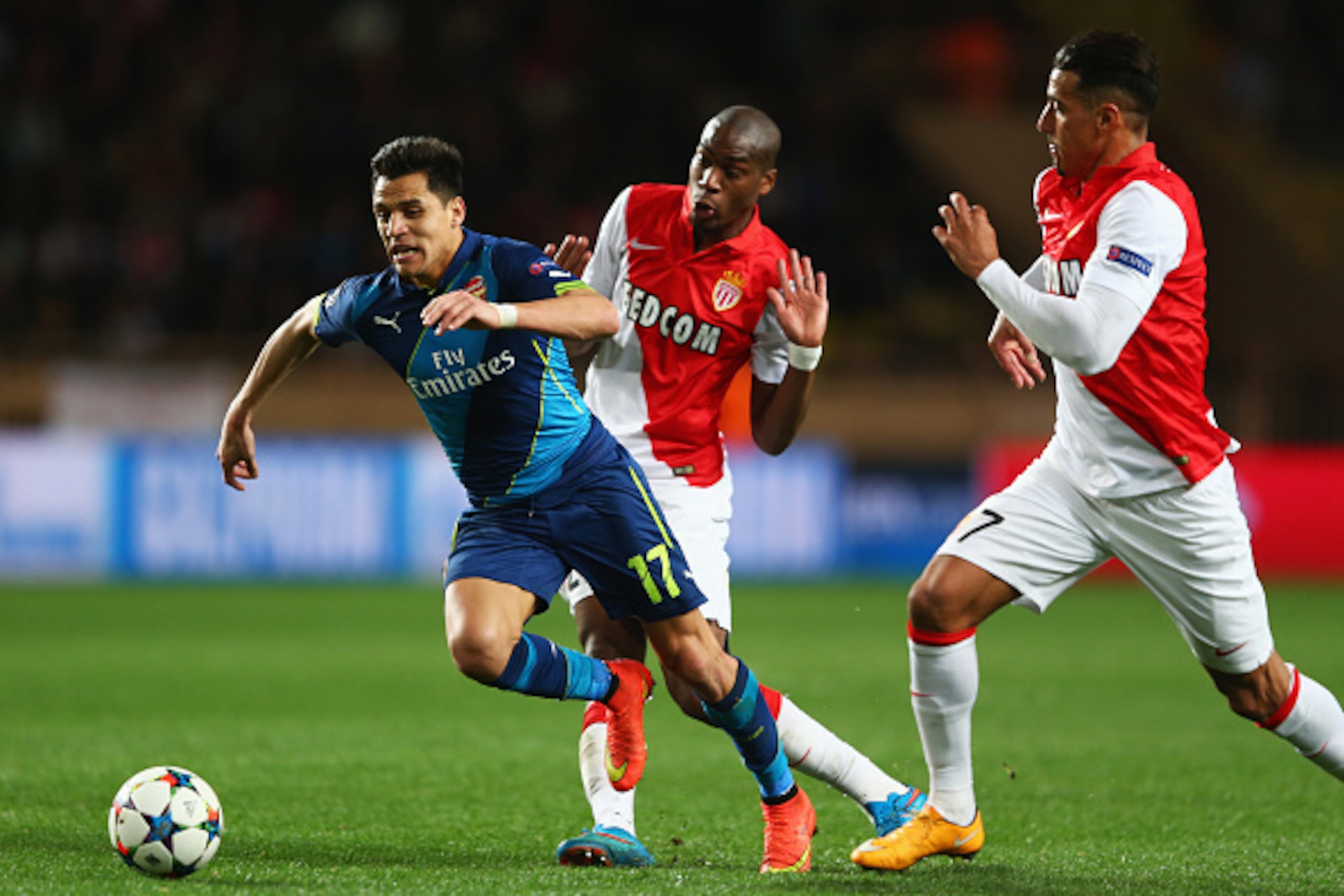 MONACO - MARCH 17:  Alexis Sanchez of Arsenal takes on Geoffrey Kondogbia and Nabil Dirar of Monaco during the UEFA Champions League round of 16 second leg match between AS Monaco and Arsenal at Stade Louis II on March 17, 2015 in Monaco, Monaco.  (Photo 