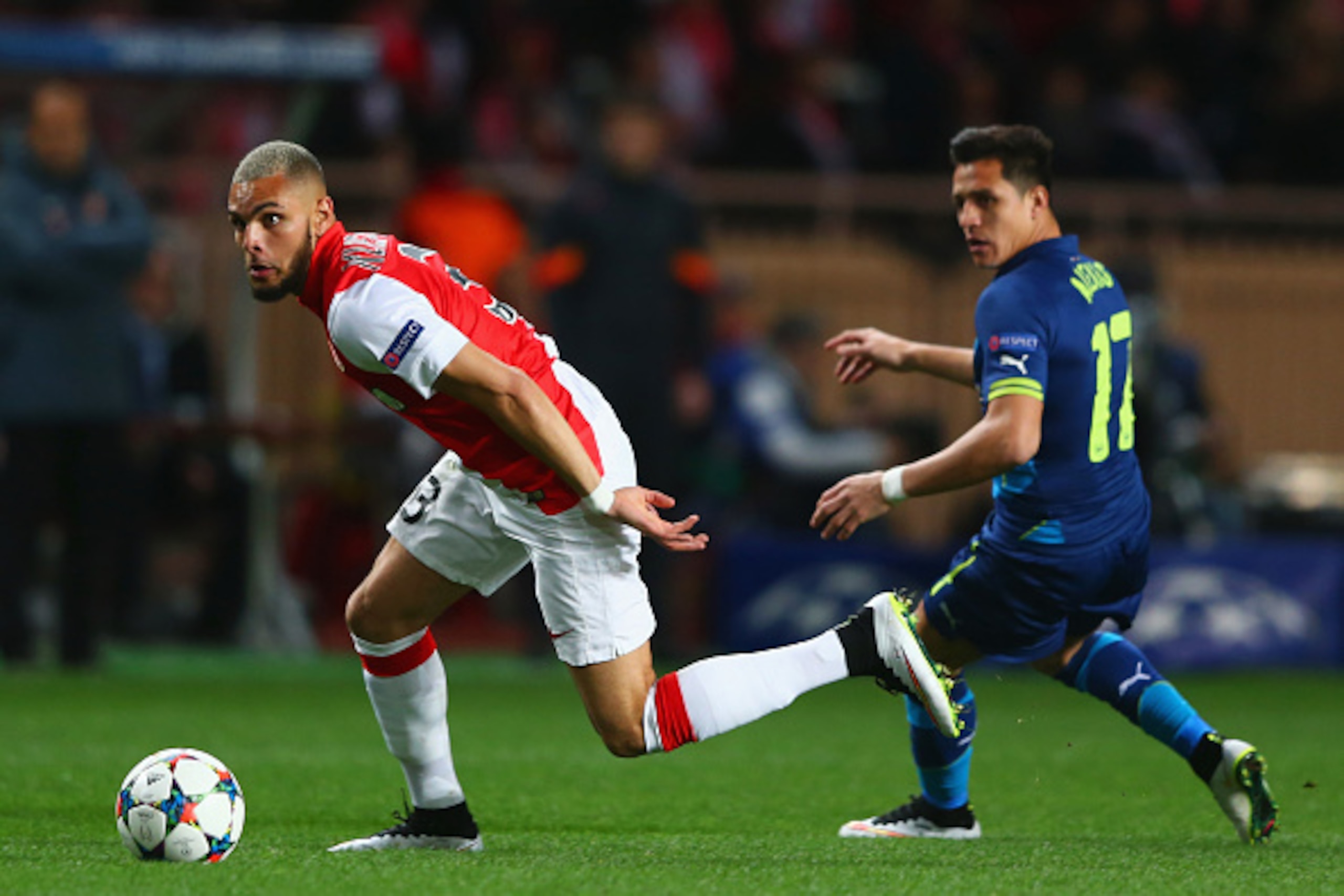 MONACO - MARCH 17:  Layvin Kurzawa of Monaco evades Alexis Sanchez of Arsenal during the UEFA Champions League round of 16 second leg match between AS Monaco and Arsenal at Stade Louis II on March 17, 2015 in Monaco, Monaco.  (Photo by Michael Steele/Gett
