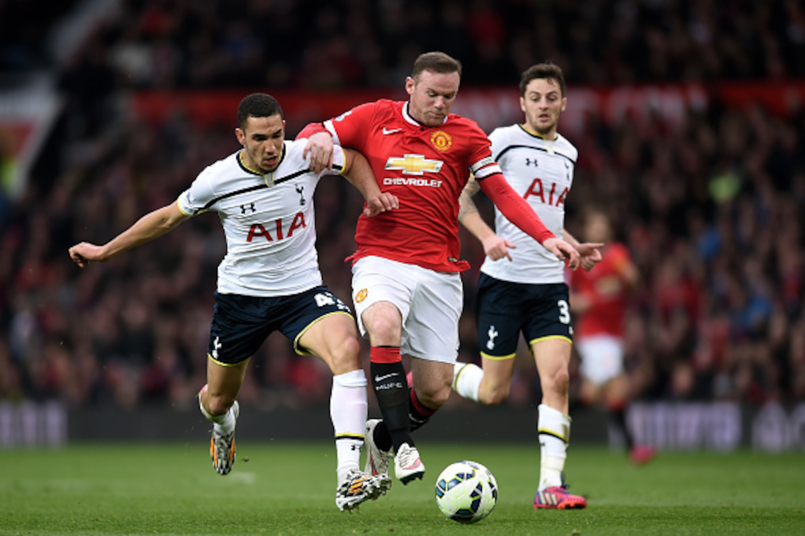 MANCHESTER, ENGLAND - MARCH 15: Wayne Rooney of Manchester United shrugs off the challenge from Nabil Bentaleb of Spurs during the Barclays Premier League match between Manchester United and Tottenham Hotspur at Old Trafford on March 15, 2015 in Manchest MANCHESTER, ENGLAND - MARCH 15: Wayne Rooney of Manchester United shrugs off the challenge from Nabil Bentaleb of Spurs during the Barclays Premier League match between Manchester United and Tottenham Hotspur at Old Trafford on March 15, 2015 in Manchest