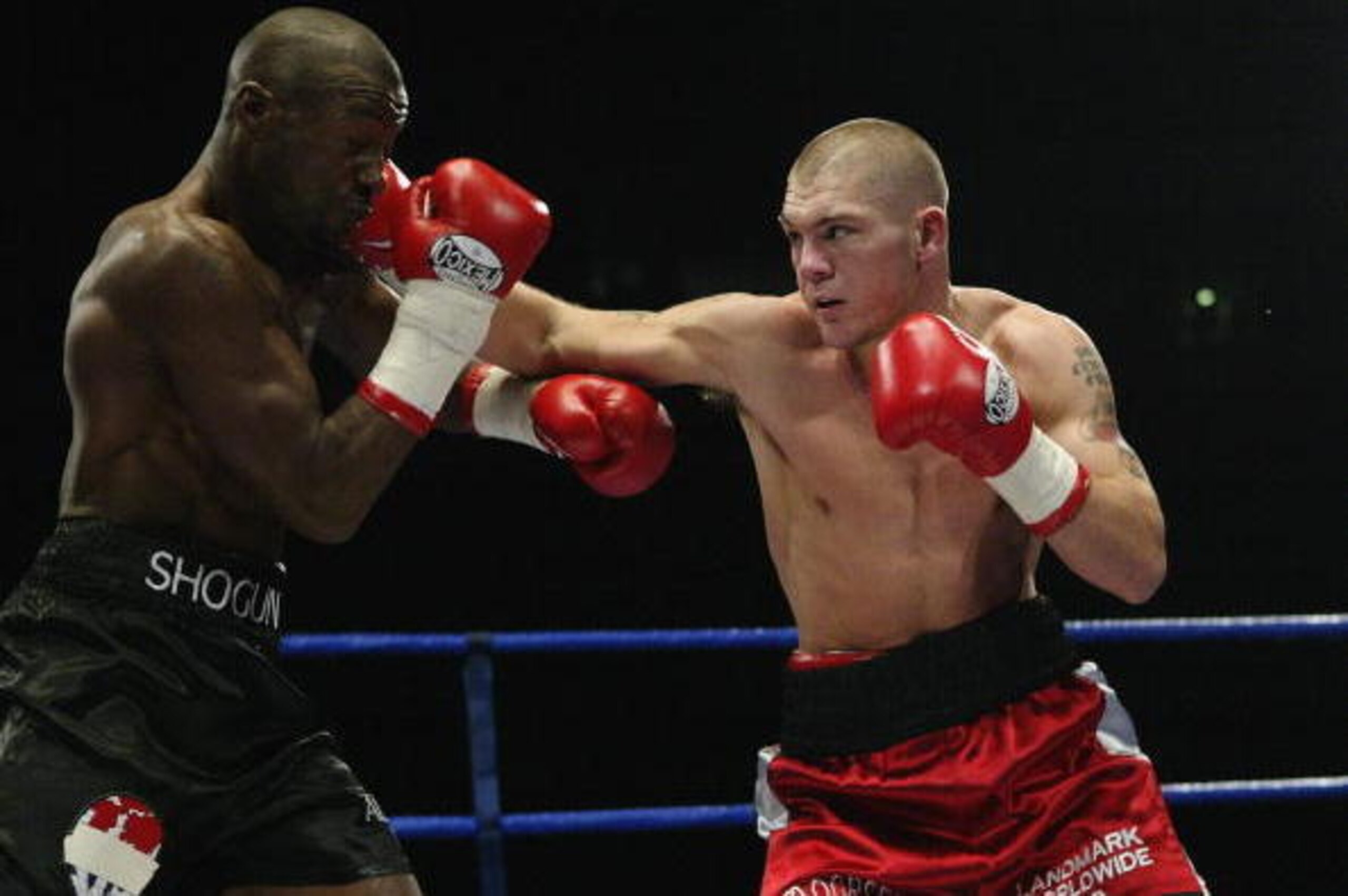 MANCHESTER - OCTOBER 18: Jamie Moore of Great Britain lands with a straight right on Gary Logan of Great Britain during the British and Commonwealth Light Middle-weight fight between Gary Logan of Great Britain and Jamie Moore of Great Britain on October MANCHESTER - OCTOBER 18: Jamie Moore of Great Britain lands with a straight right on Gary Logan of Great Britain during the British and Commonwealth Light Middle-weight fight between Gary Logan of Great Britain and Jamie Moore of Great Britain on October
