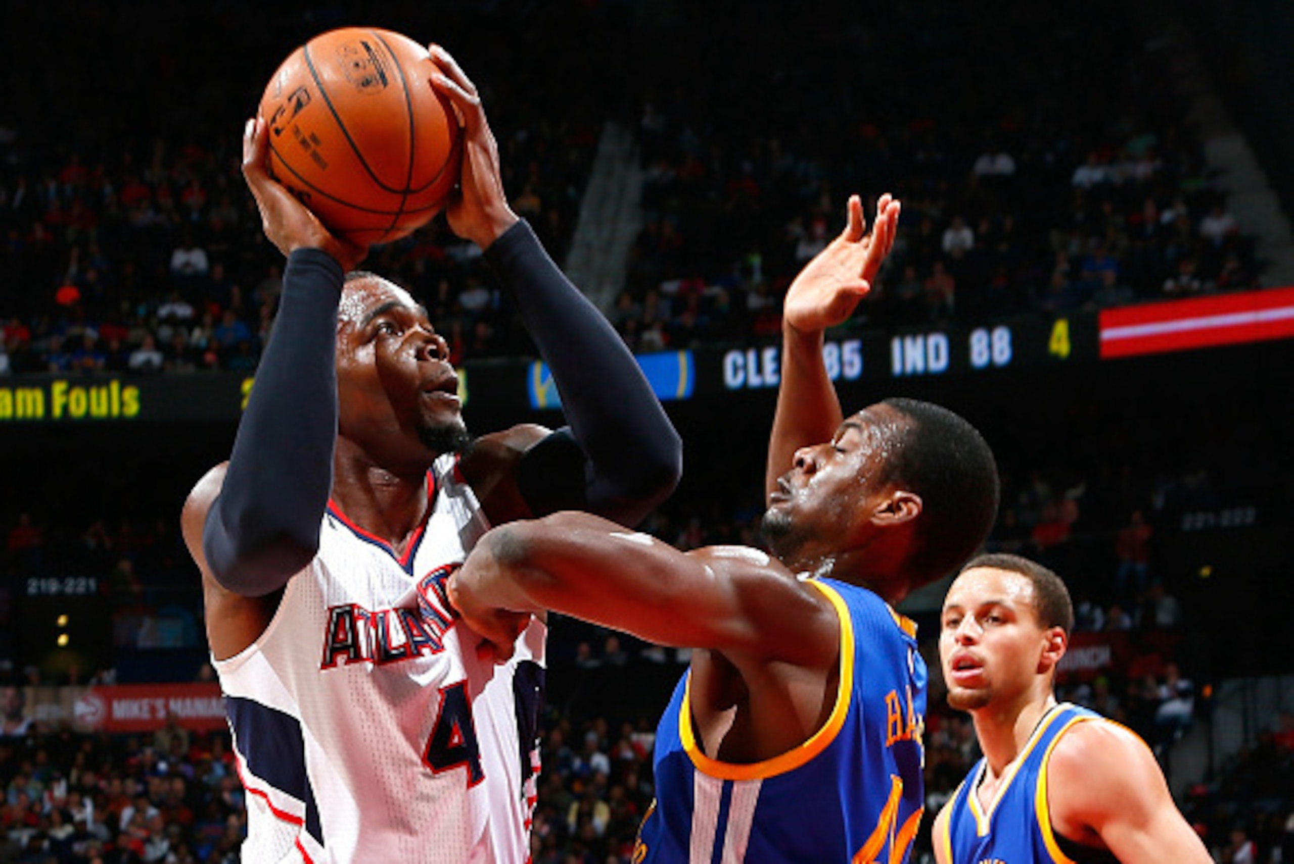 ATLANTA, GA - FEBRUARY 06:  Harrison Barnes #40 of the Golden State Warriors defends against Paul Millsap #4 of the Atlanta Hawks at Philips Arena on February 6, 2015 in Atlanta, Georgia.  NOTE TO USER: User expressly acknowledges and agrees that, by down