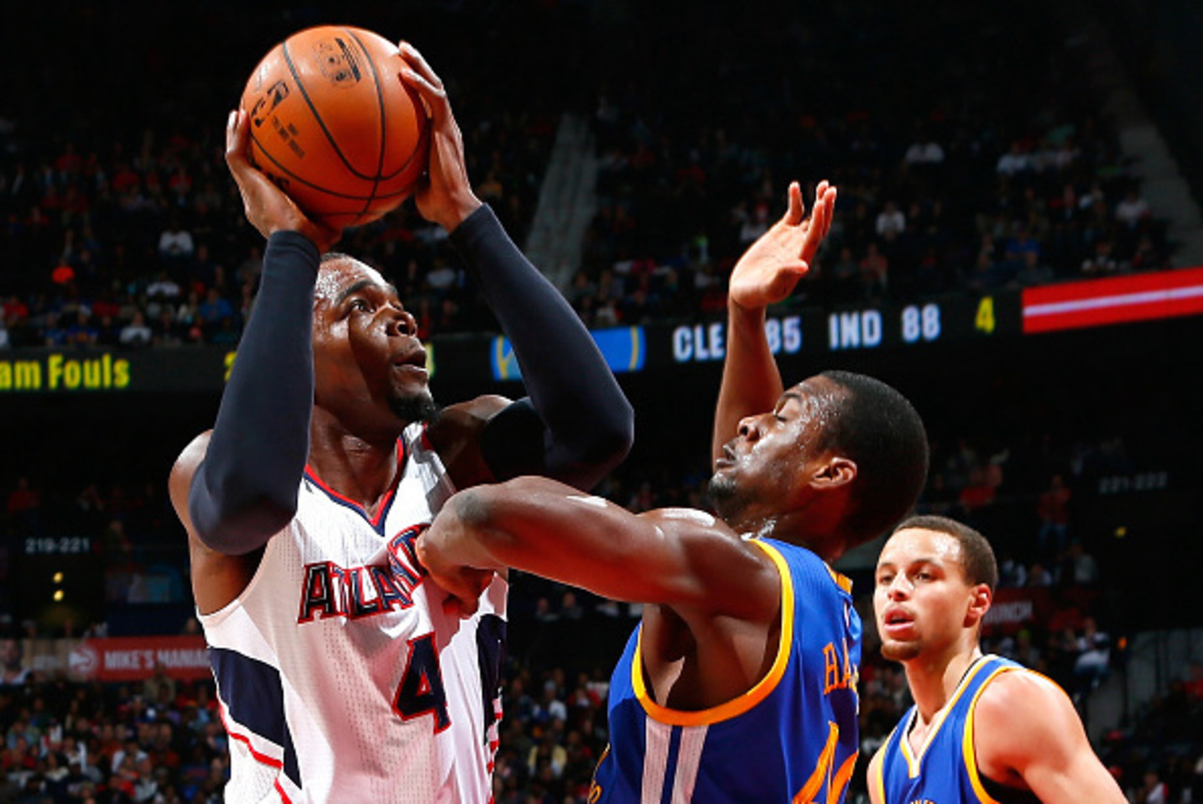 ATLANTA, GA - FEBRUARY 06:  Harrison Barnes #40 of the Golden State Warriors defends against Paul Millsap #4 of the Atlanta Hawks at Philips Arena on February 6, 2015 in Atlanta, Georgia.  NOTE TO USER: User expressly acknowledges and agrees that, by down