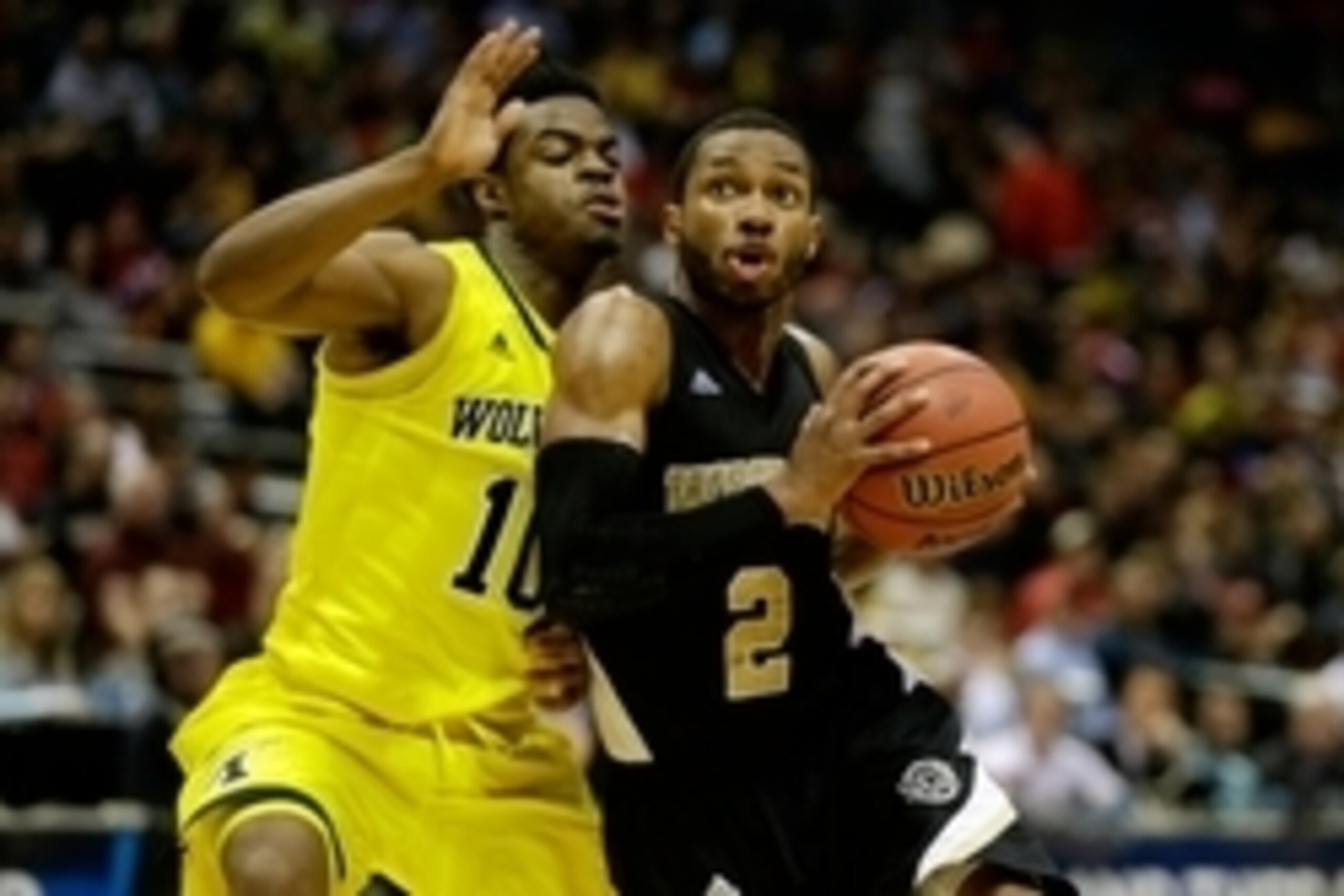 Mar 20, 2014; Milwaukee, WI, USA; Wofford Terriers guard Karl Cochran (2) drives past Michigan Wolverines guard Derrick Walton Jr. (10) during the second round of the 2014 NCAA Tournament at BMO Harris Bradley Center. Michigan defeated Wofford 57-40. Mand