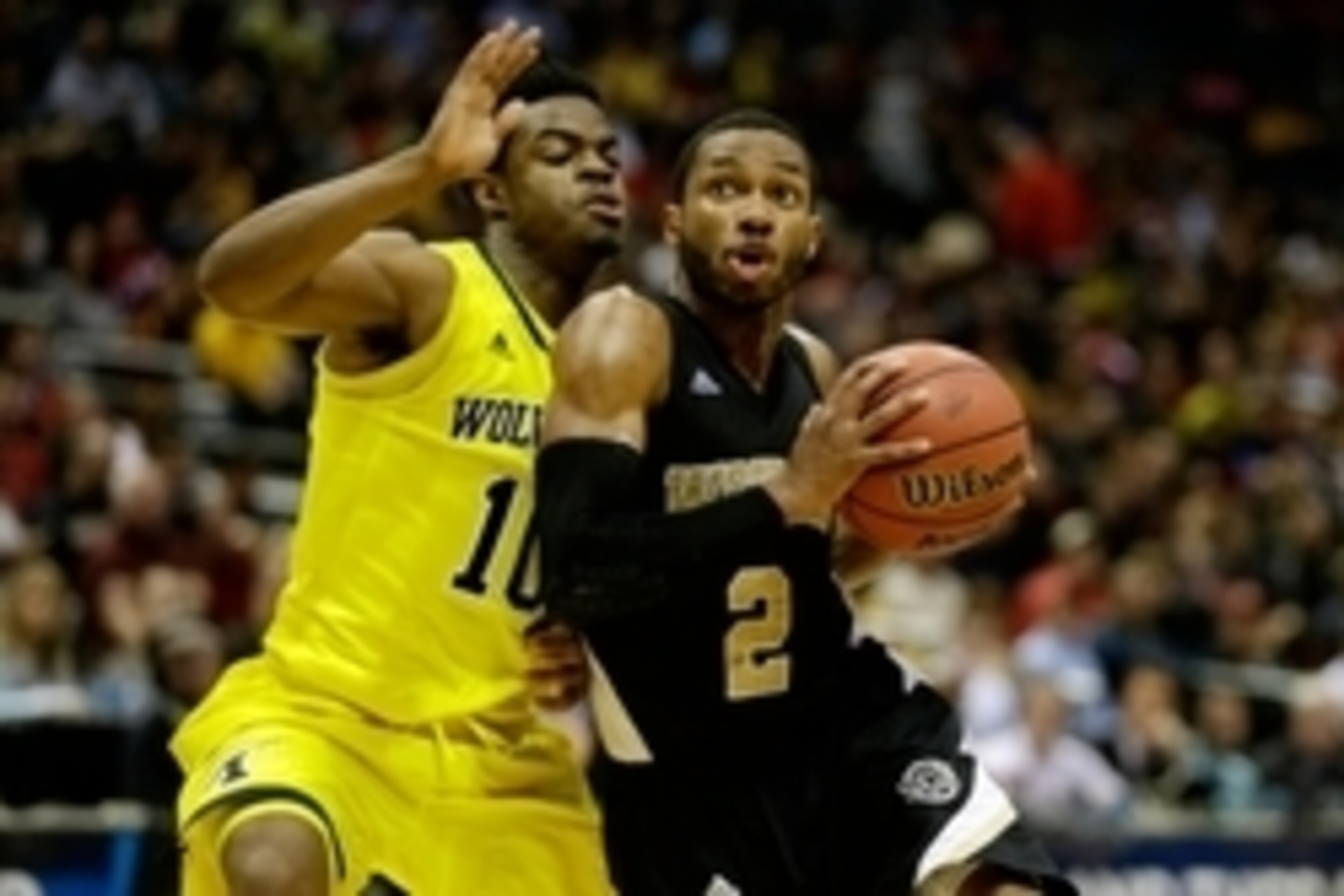 Mar 20, 2014; Milwaukee, WI, USA; Wofford Terriers guard Karl Cochran (2) drives past Michigan Wolverines guard Derrick Walton Jr. (10) during the second round of the 2014 NCAA Tournament at BMO Harris Bradley Center. Michigan defeated Wofford 57-40. Mand Mar 20, 2014; Milwaukee, WI, USA; Wofford Terriers guard Karl Cochran (2) drives past Michigan Wolverines guard Derrick Walton Jr. (10) during the second round of the 2014 NCAA Tournament at BMO Harris Bradley Center. Michigan defeated Wofford 57-40. Mand