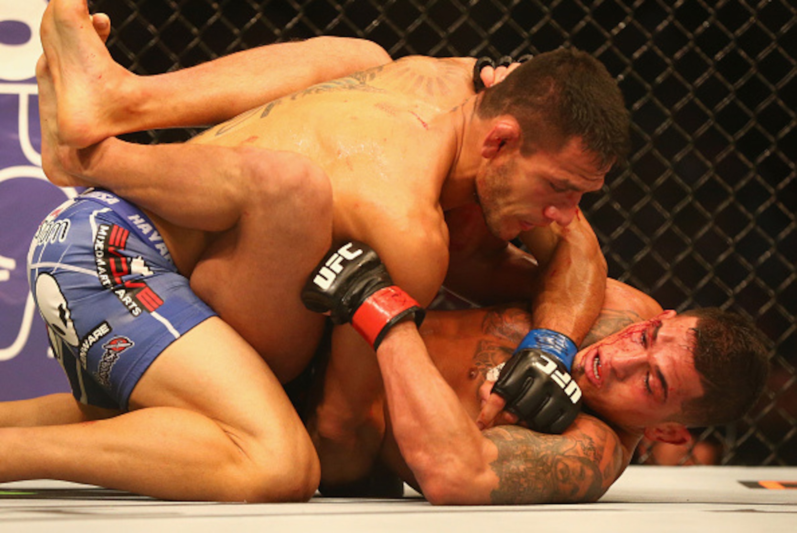 DALLAS, TX - MARCH 14:  Rafael dos Anjos, top fights with Anthony Pettis in the Lightweight Title bout during the UFC 185 event at American Airlines Center on March 14, 2015 in Dallas, Texas.  (Photo by Ronald Martinez/Getty Images)